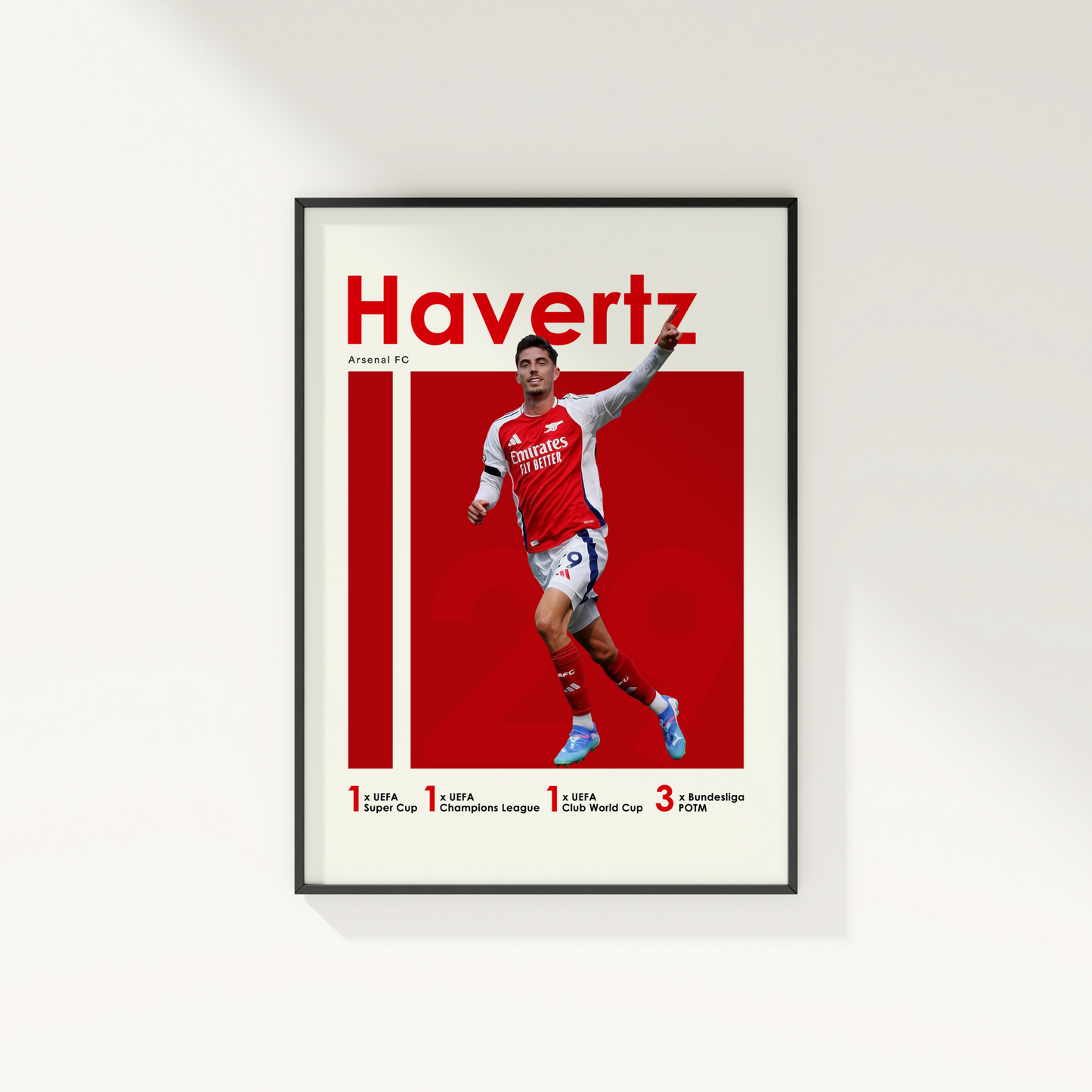 framed poster mockup of soccer player kai havertz hanging on a white wall