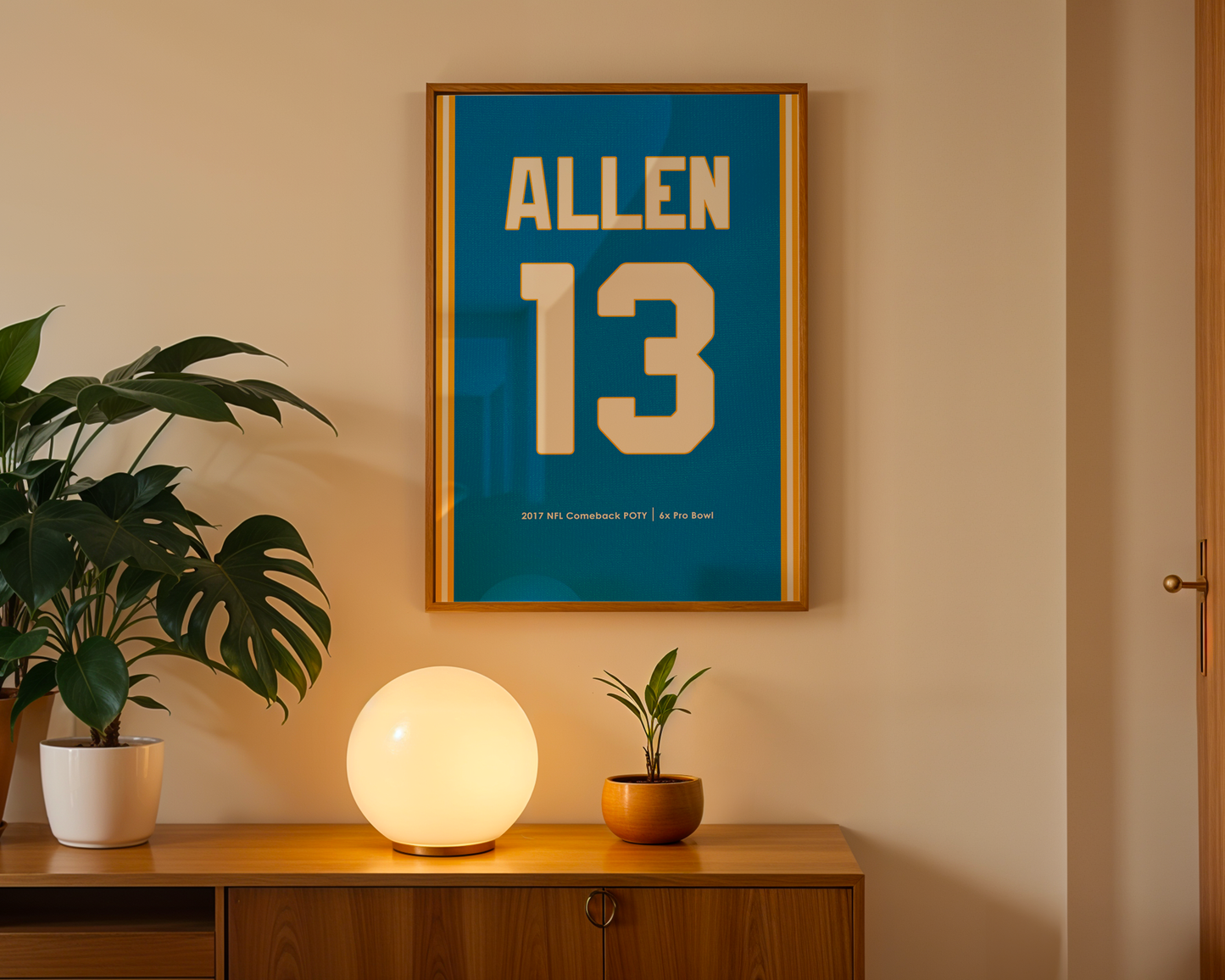 Framed poster with 'Allen 13' on a wall above a wooden cabinet with decorative items.