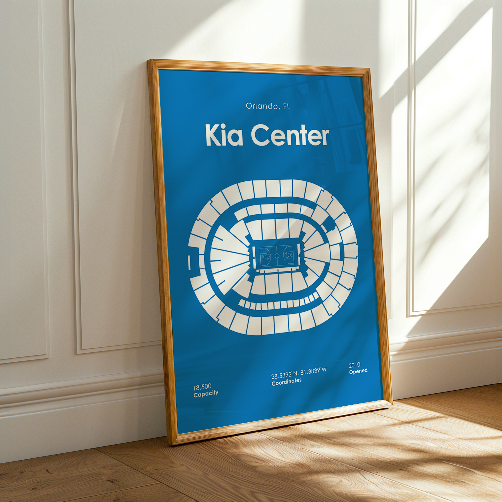Framed poster of the Kia Center in Orlando, FL on a wall.