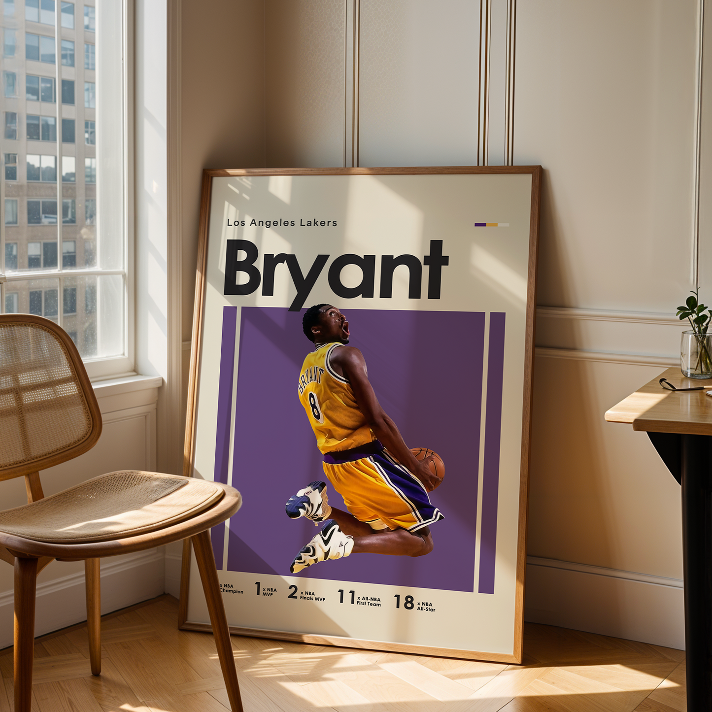 Framed poster of a basketball player in a room with a chair and table.