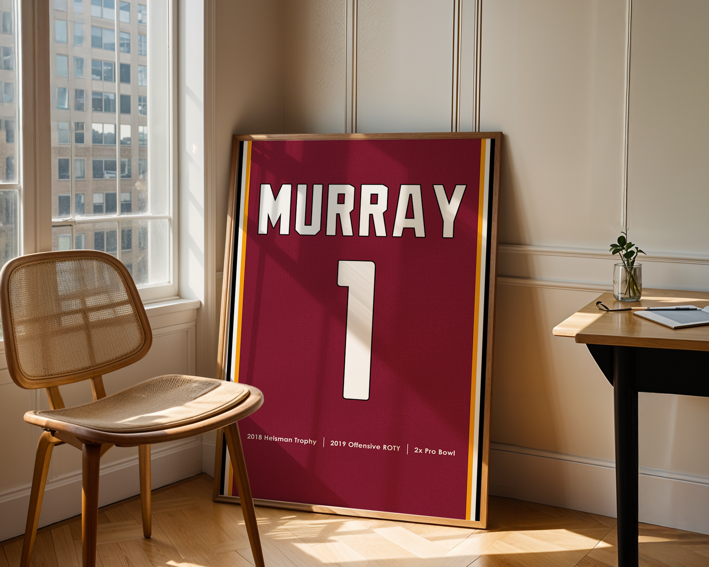 Framed sports jersey with 'MURRAY' and number '1' in a room with a window and chair.