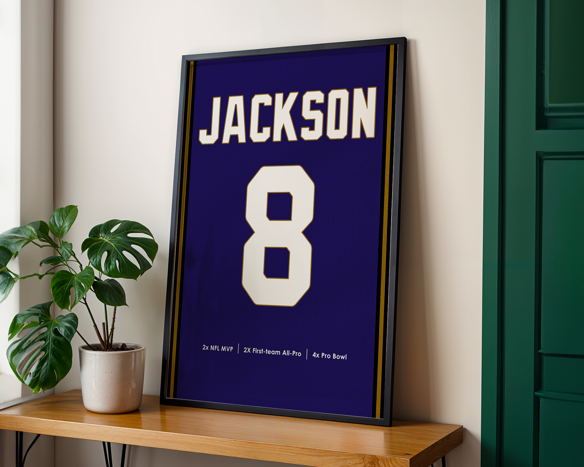 Framed sports jersey with 'Jackson' and number '8' on a wooden shelf.