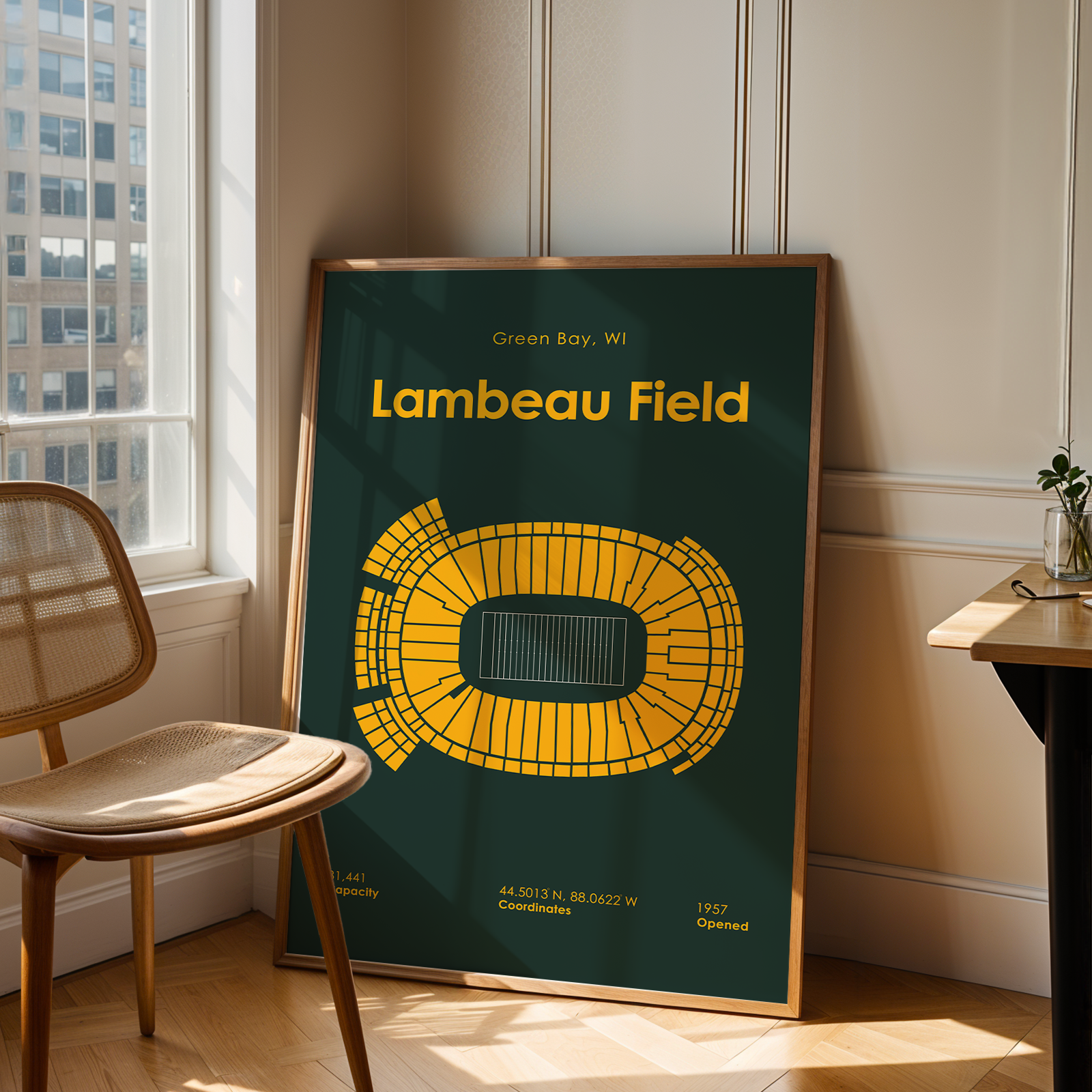 Poster of Lambeau Field in a room with a chair and table.