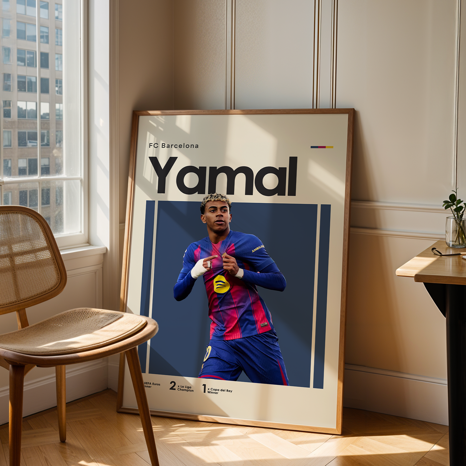 Framed poster of a soccer player in a room with a chair and table.