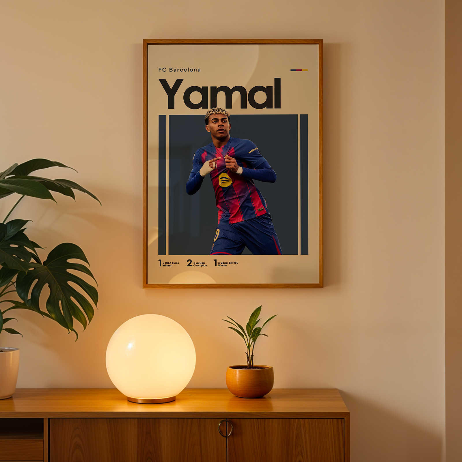 Framed poster of a football player named Yamal on a wall above a wooden cabinet with decorative items.