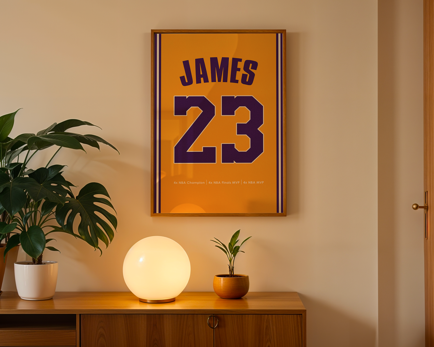 Framed sports jersey with 'JAMES 23' on a wall above a wooden cabinet with decorative items.