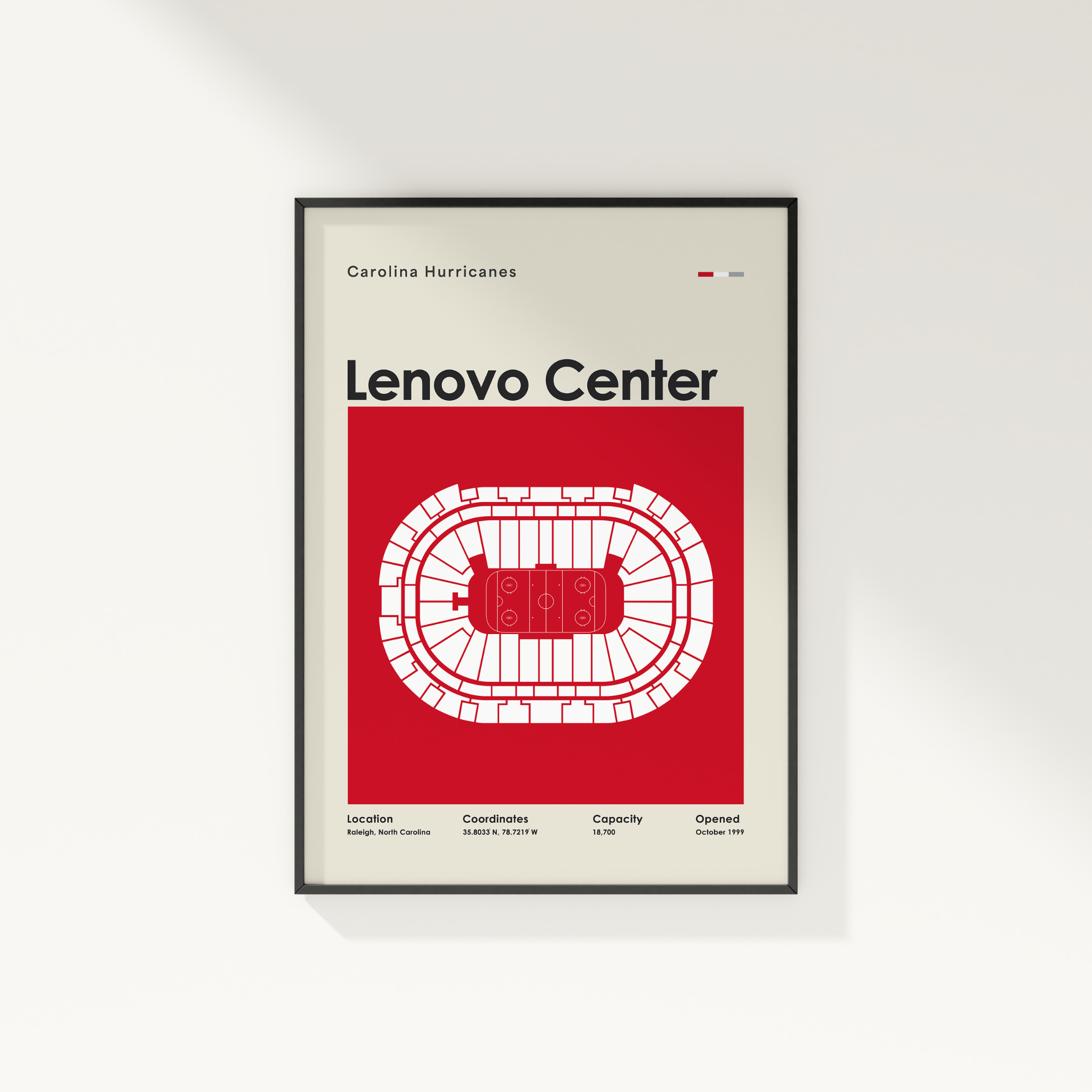 Framed poster of Lenovo Center with Carolina Hurricanes branding on a white wall.