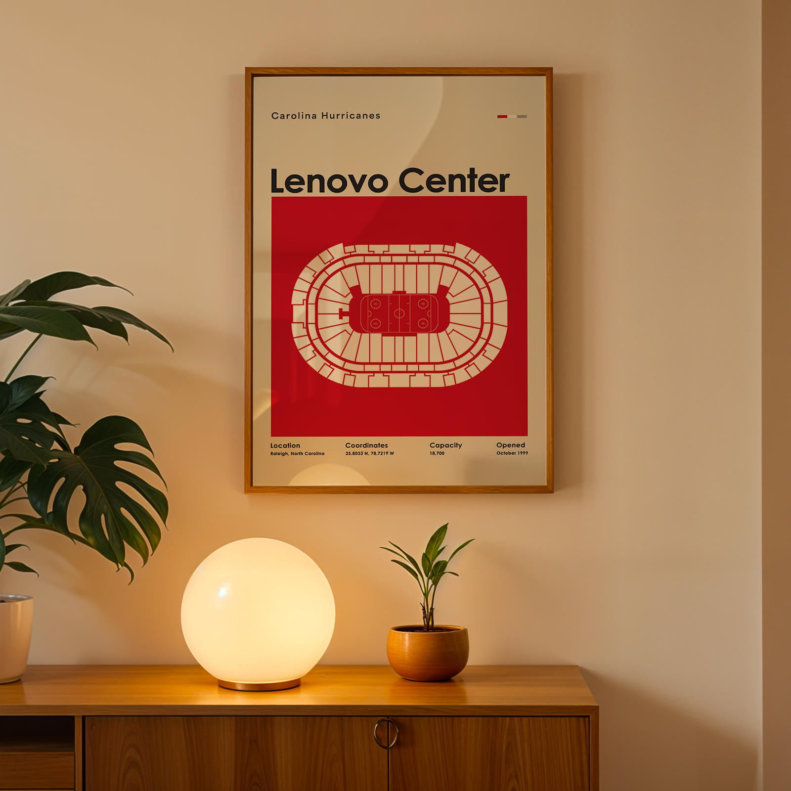 Framed Lenovo Center poster on a wall above a wooden cabinet with decorative items.