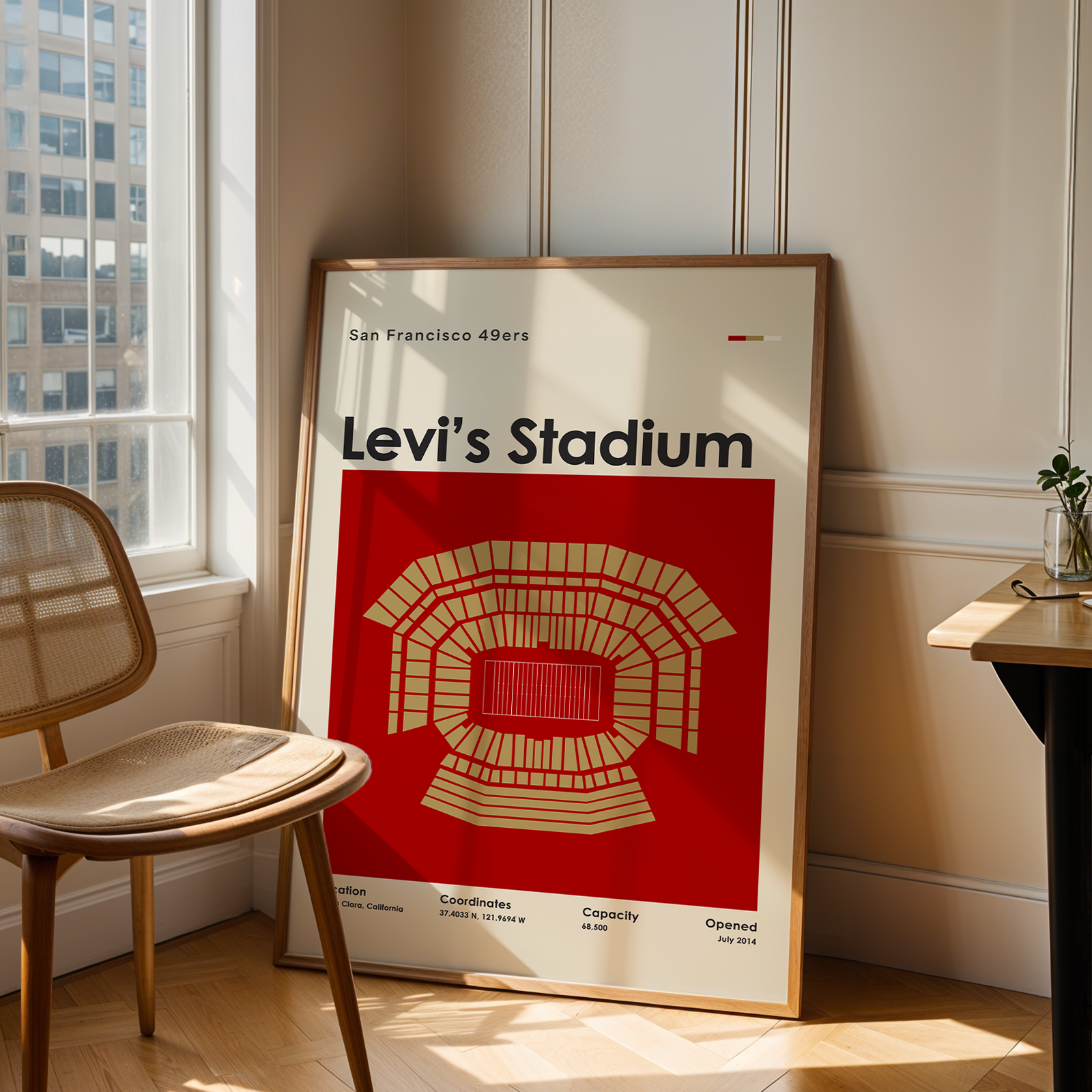 Framed Levi's Stadium poster on a wall next to a chair and window.