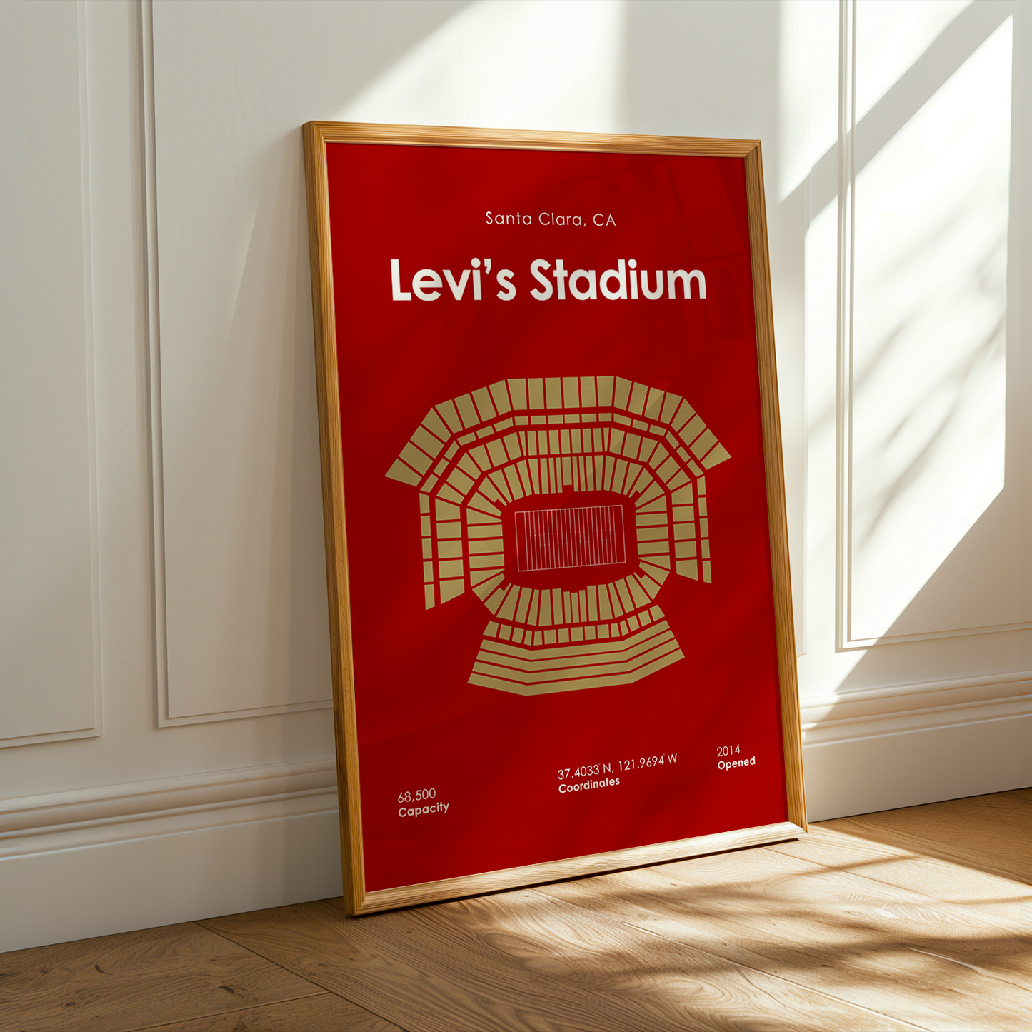 Framed poster of Levi's Stadium on a wall with sunlight casting shadows.
