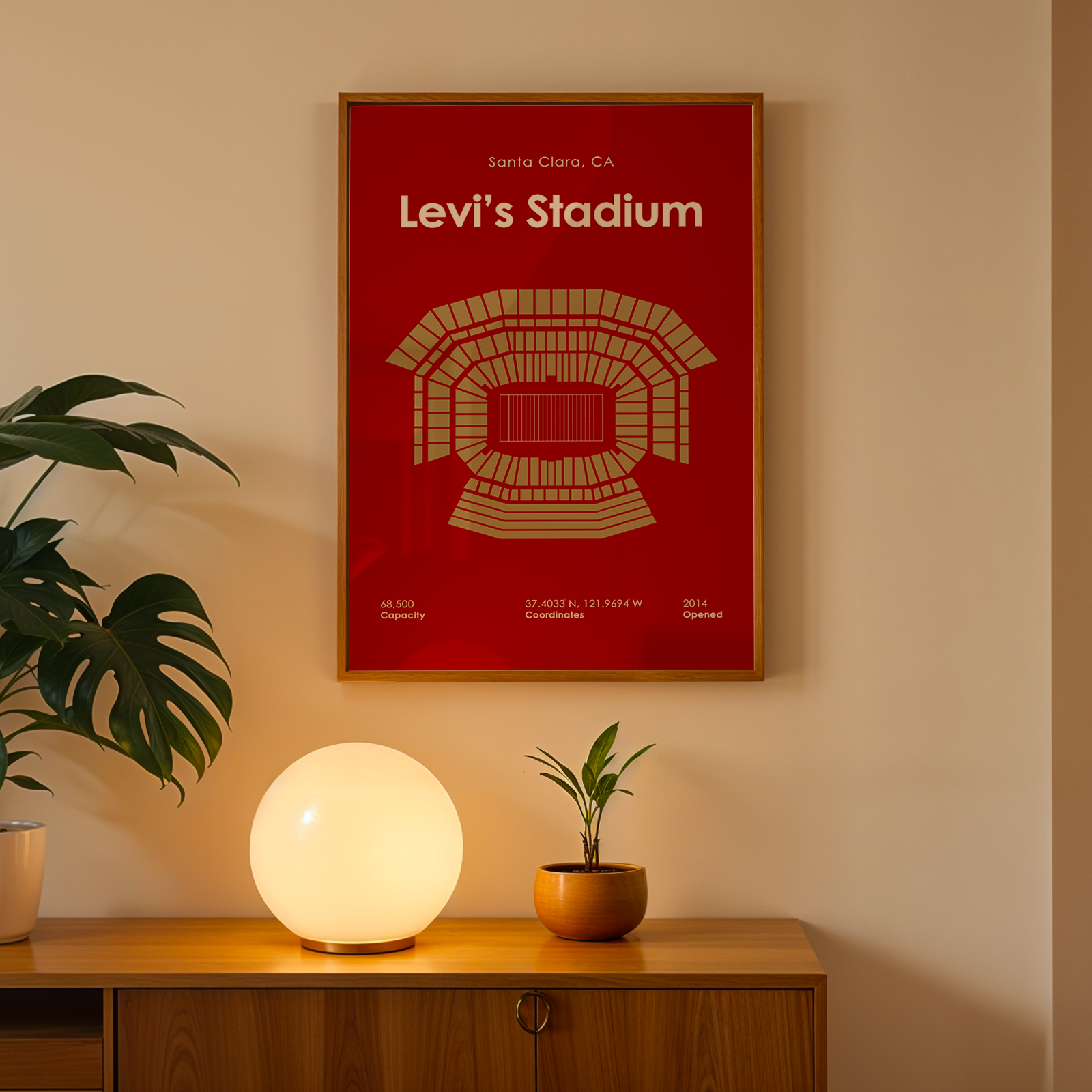 Framed Levi's Stadium poster on a wall above a wooden cabinet with decorative items.