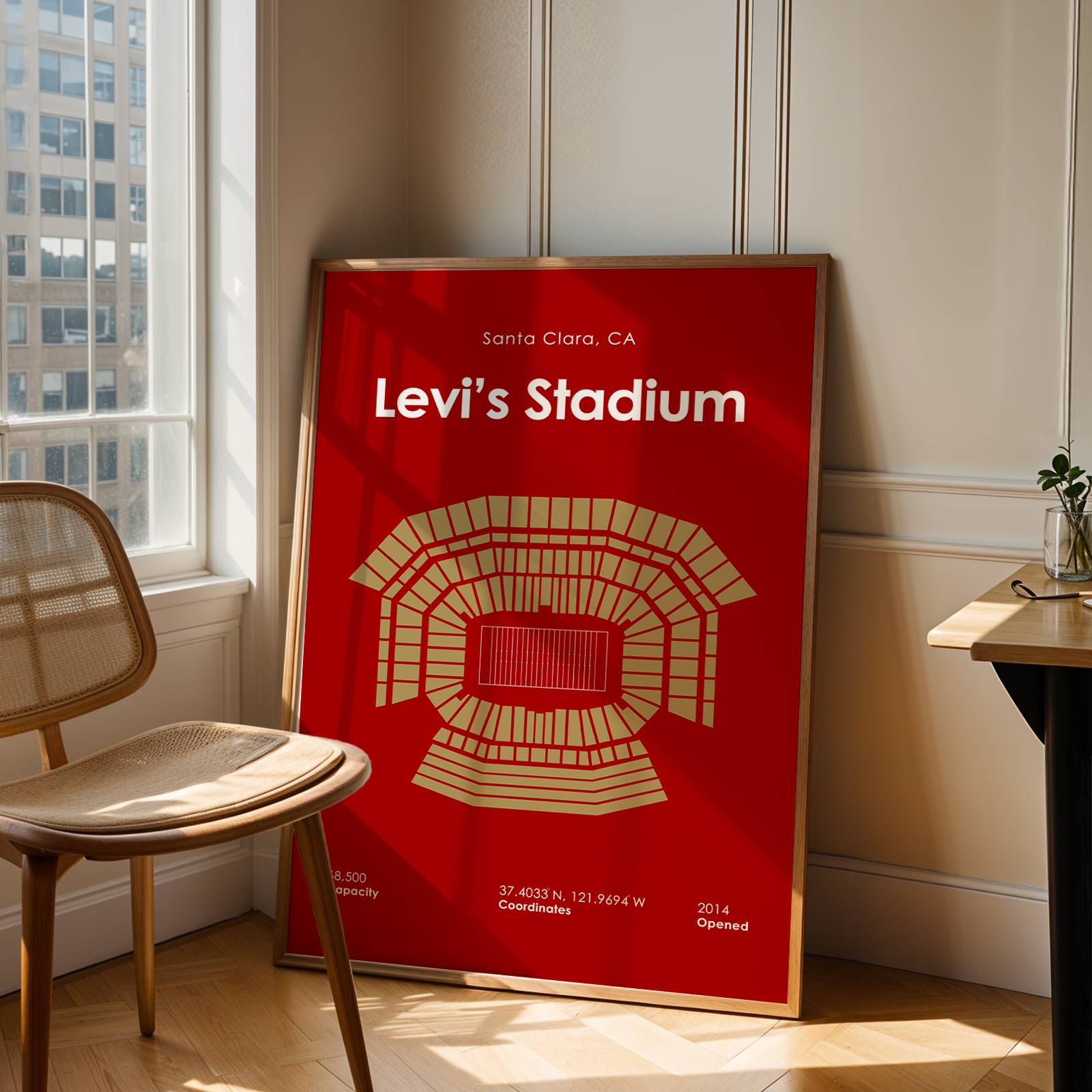 Red poster of Levi's Stadium in a room with a chair and table.