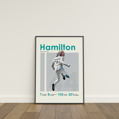 framed poster mockup of formula 1 driver lewis hamilton leaning on a white wall