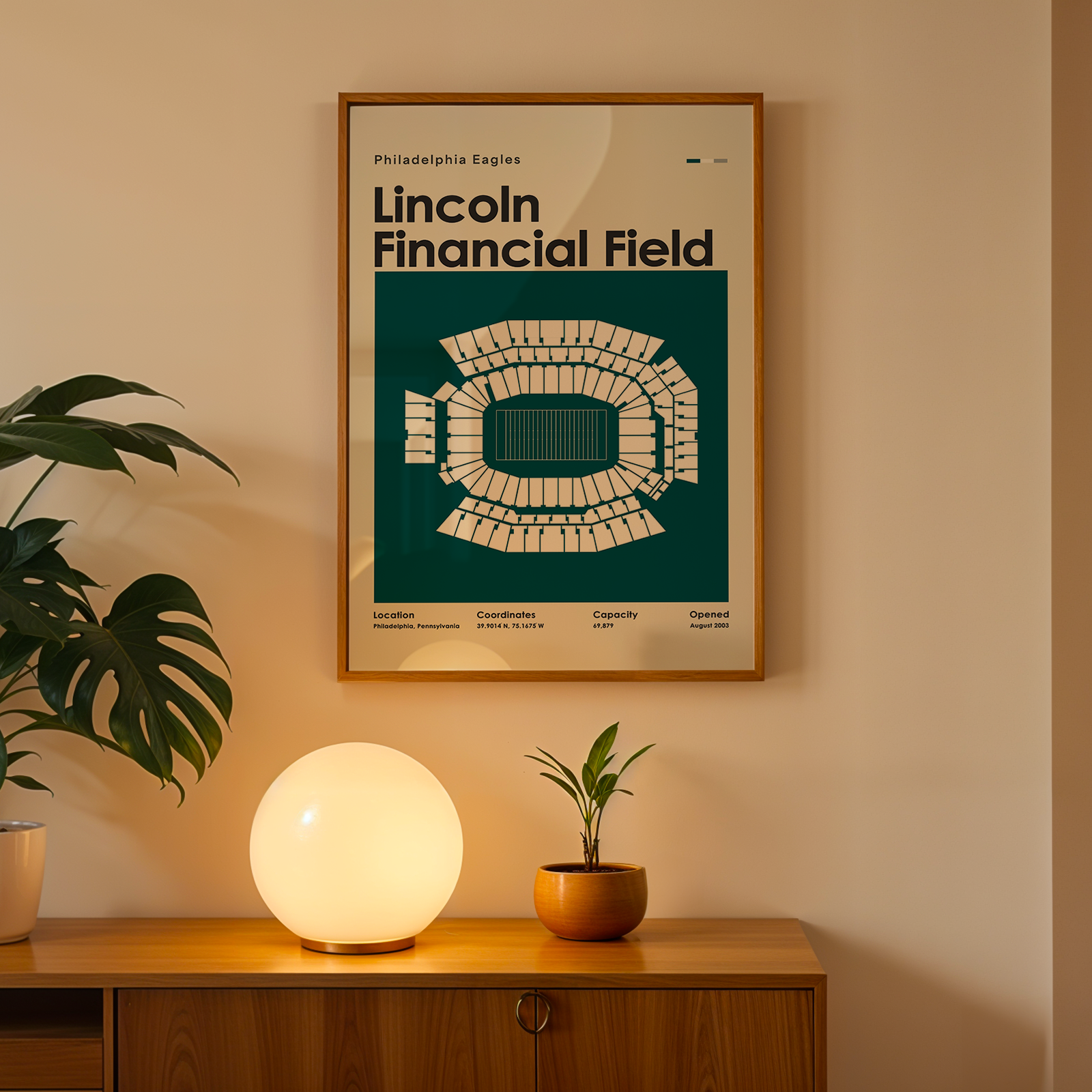 Poster of Lincoln Financial Field on a wall above a wooden cabinet with decorative items.