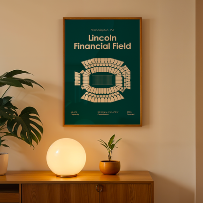 Framed poster of Lincoln Financial Field on a wall above a wooden cabinet with decorative items.