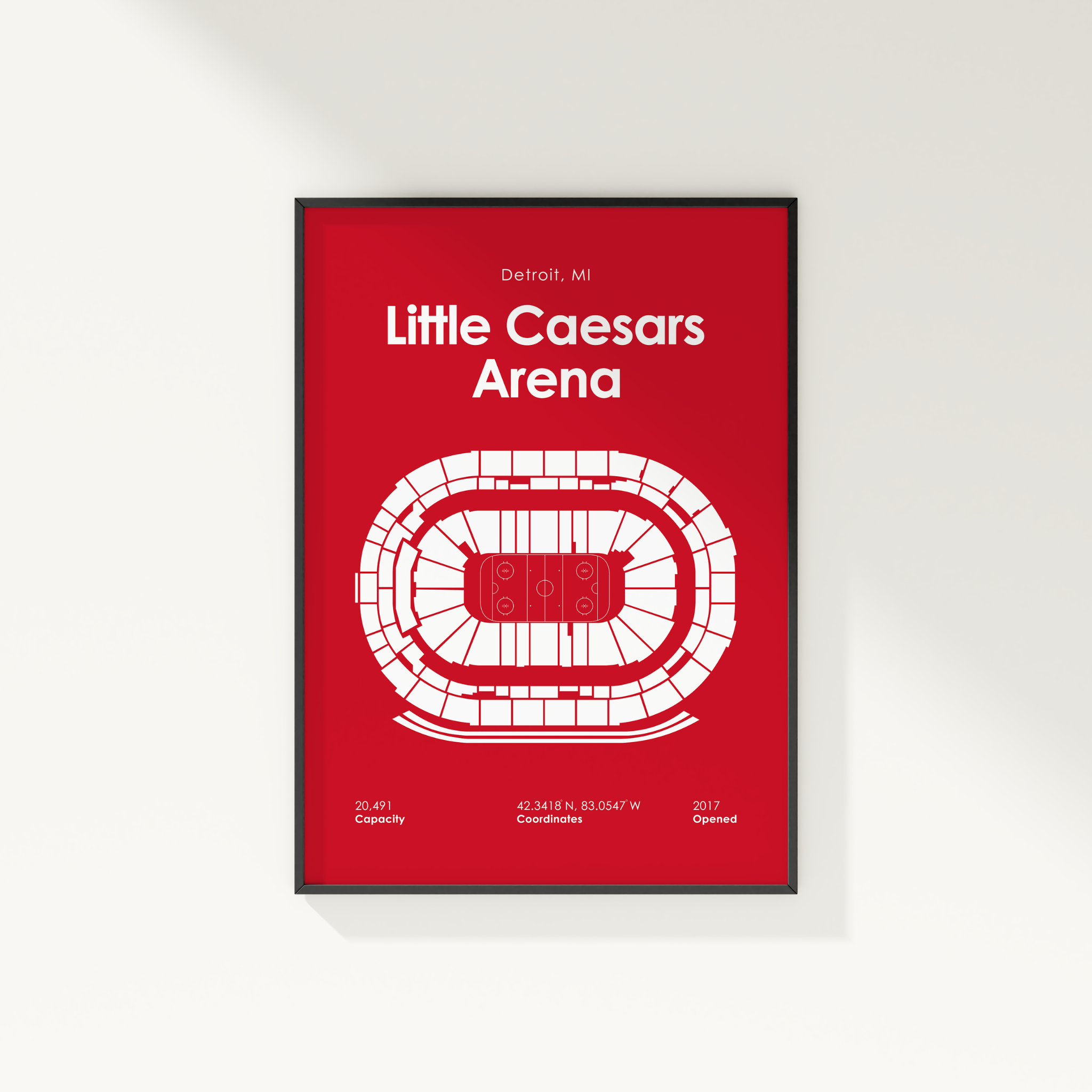 Framed poster of Little Caesars Arena layout on a red background