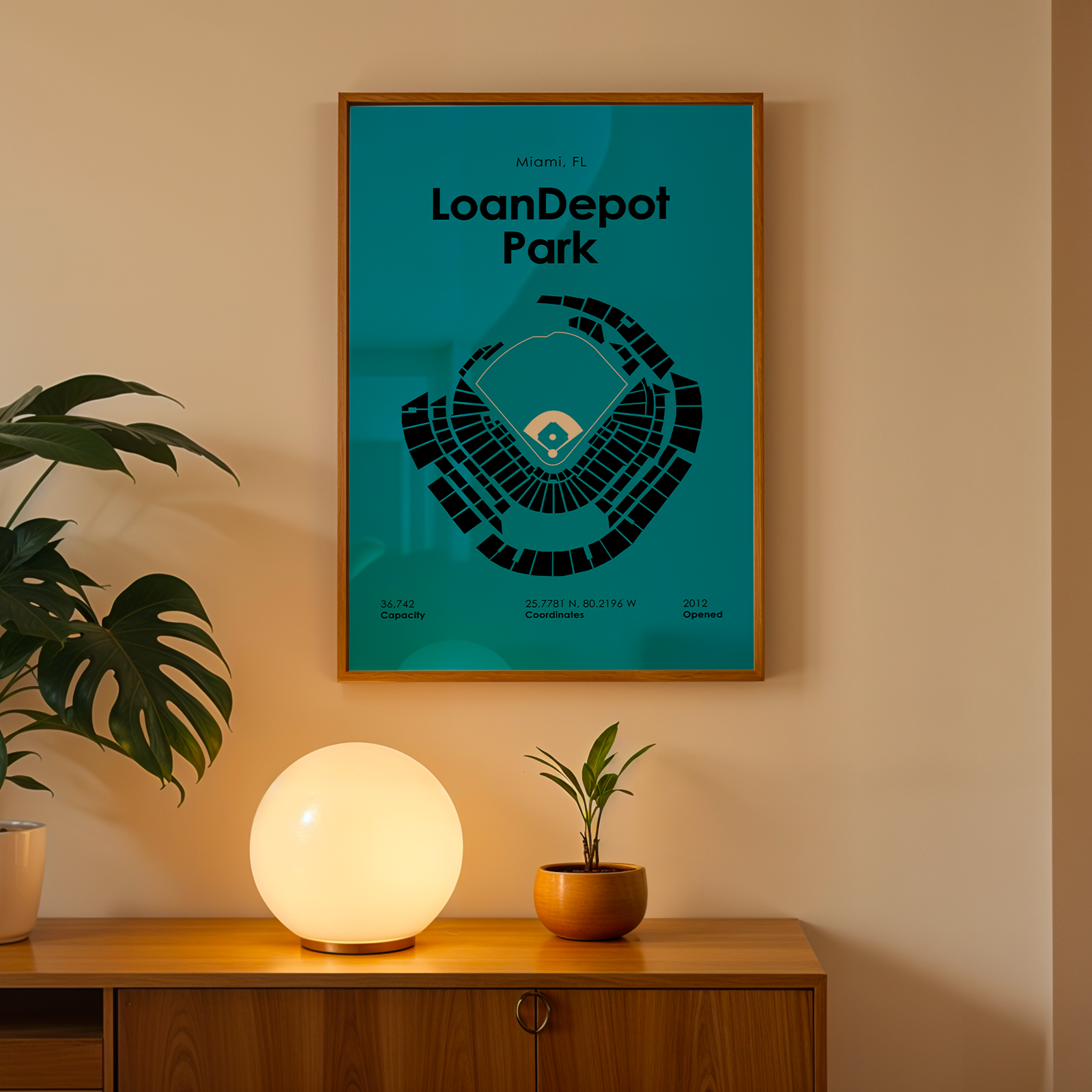 Framed poster of LoanDepot Park on a wall above a wooden cabinet with decorative items.