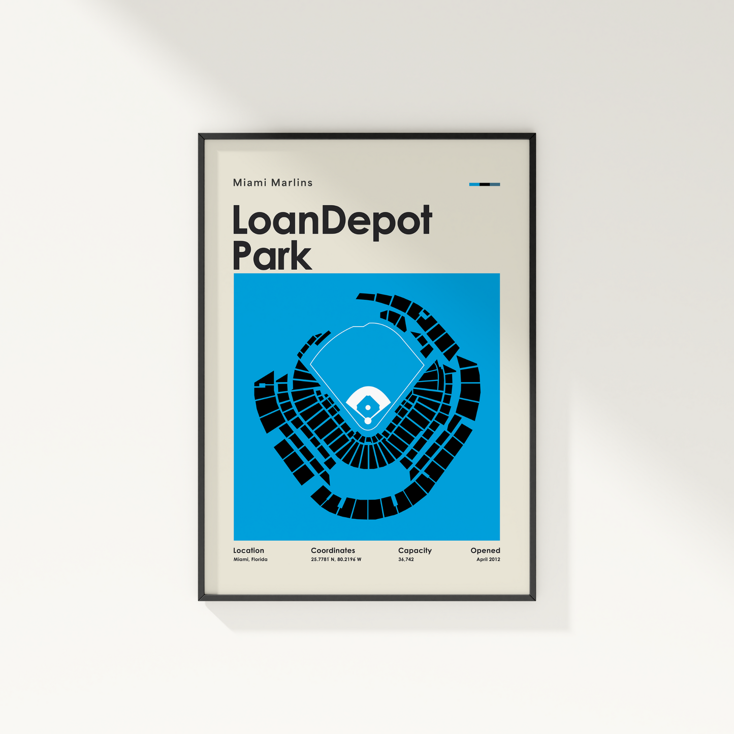 Framed poster of LoanDepot Park with seating chart and text on a white wall.
