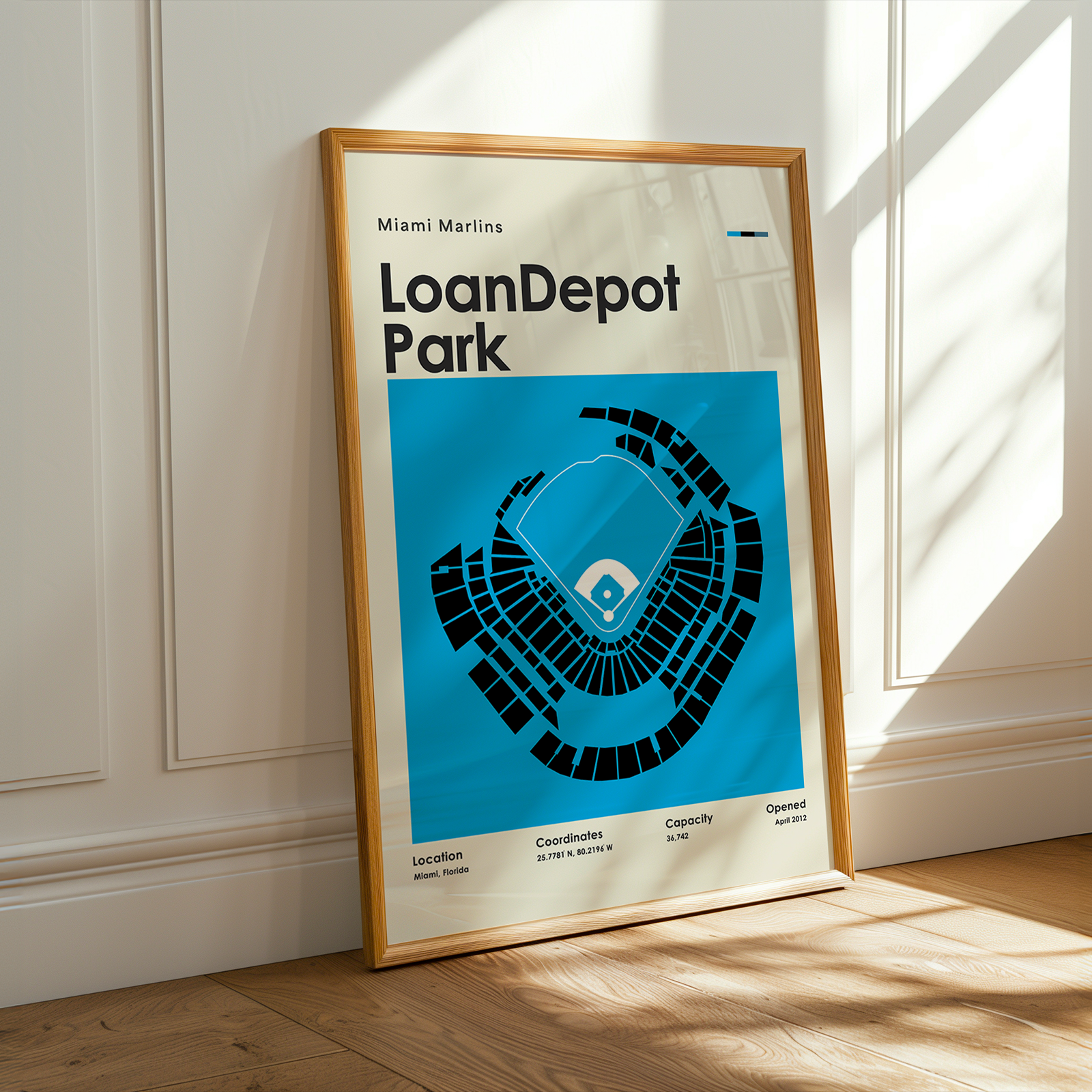 Framed poster of LoanDepot Park with Miami Marlins logo on a wall.