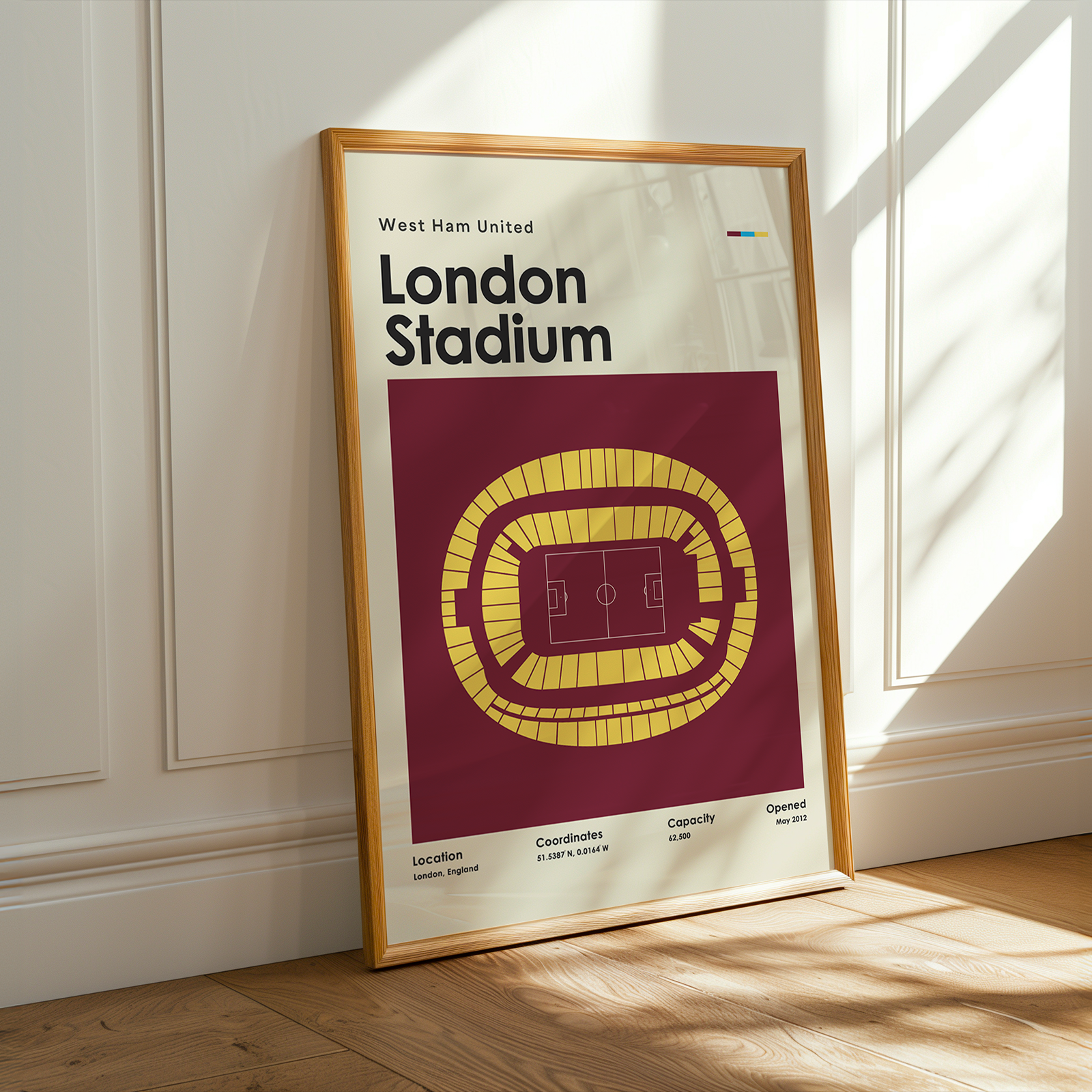 Framed poster of West Ham United London Stadium on a wall.