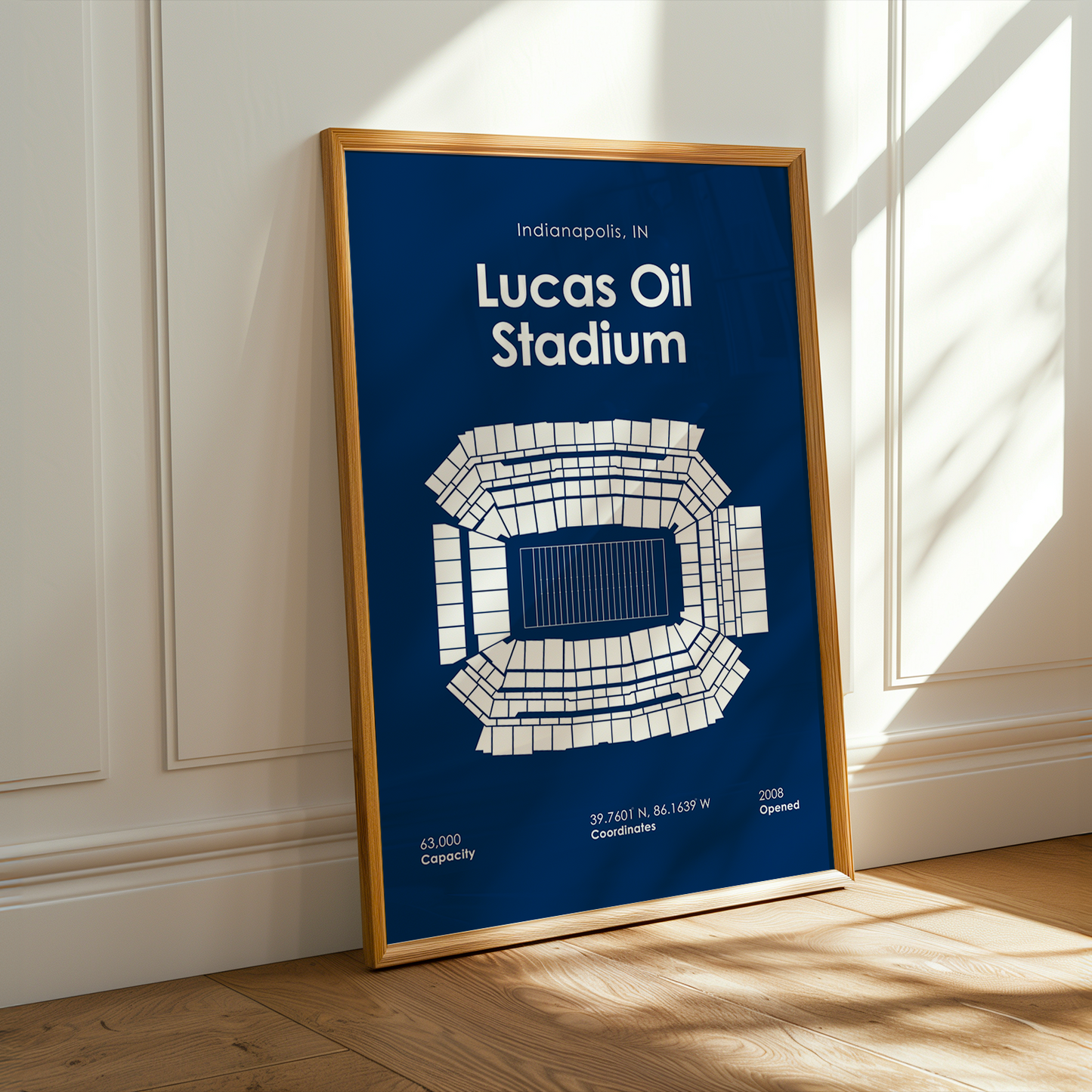 Framed poster of Lucas Oil Stadium on a wall with sunlight casting shadows.