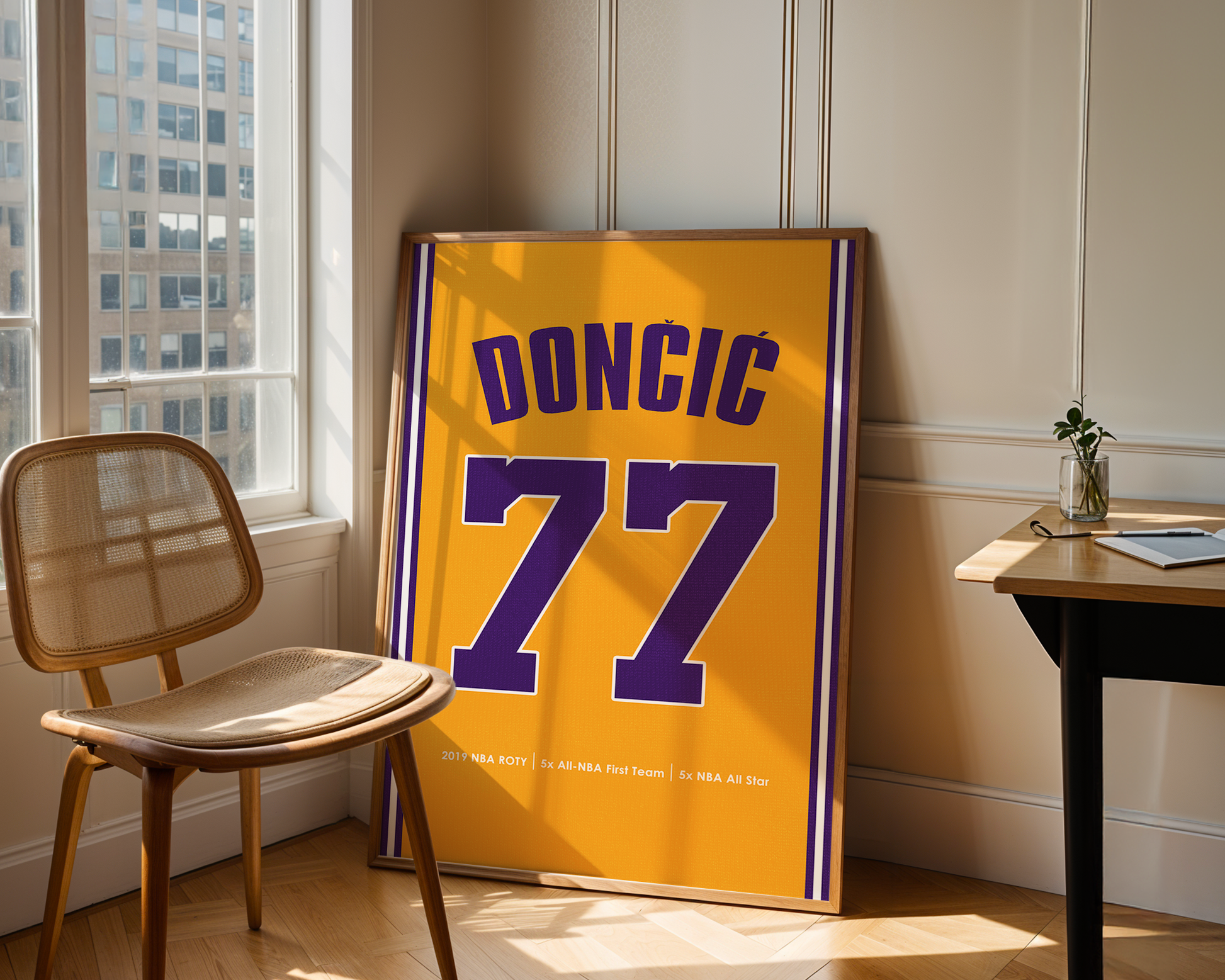 Framed sports jersey with number 77 and name 'Doncic' in a room with a chair and table.