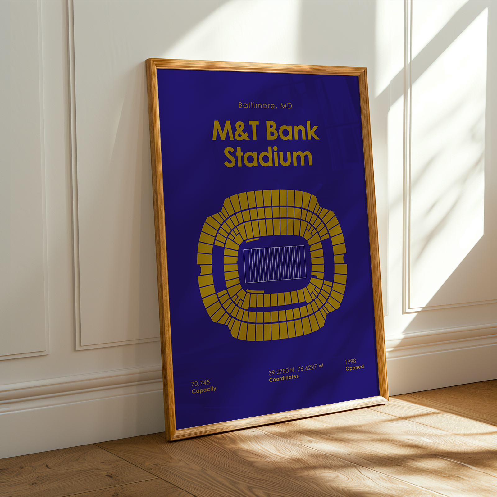 Framed poster of M&T Bank Stadium on a wall with sunlight casting shadows.