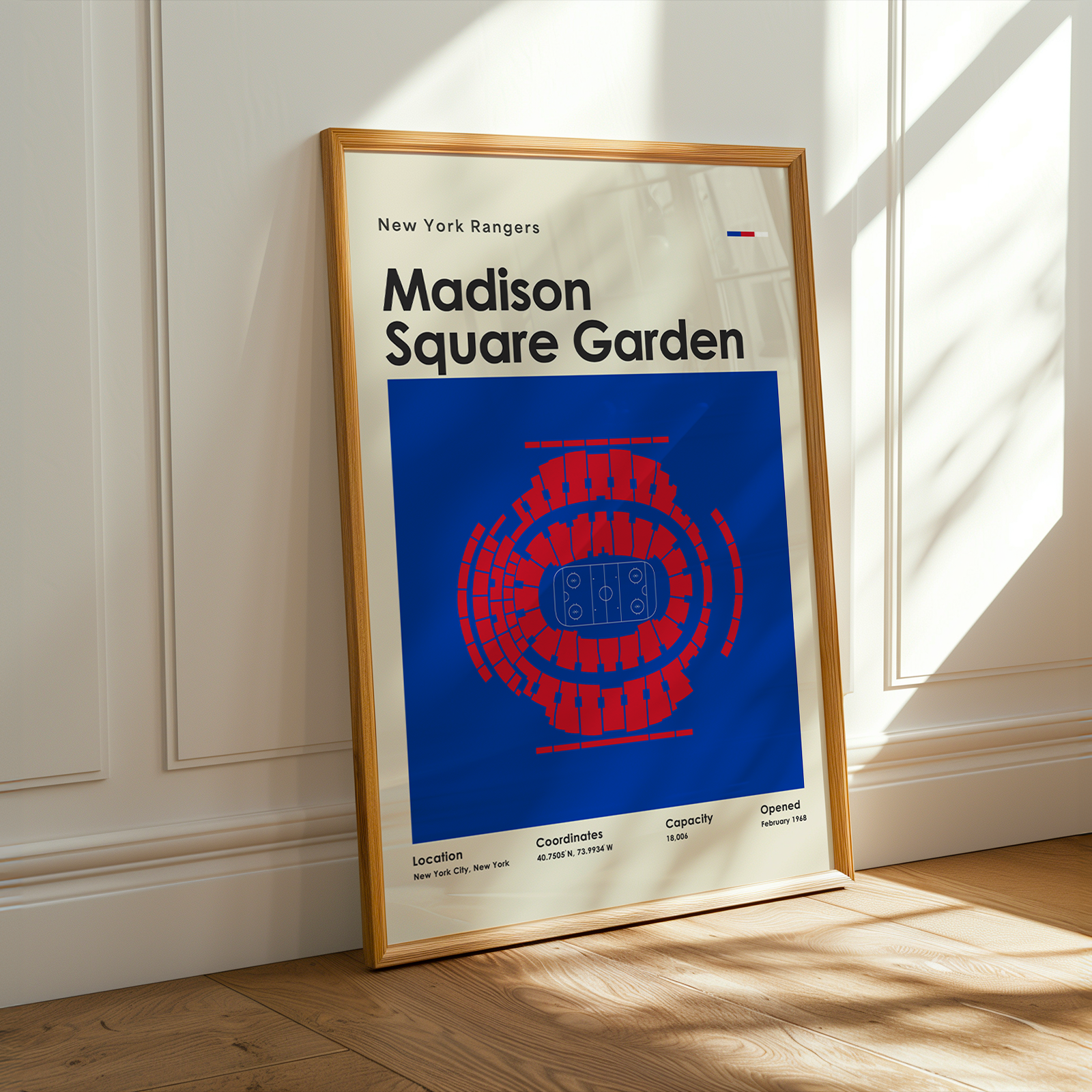 Framed poster of Madison Square Garden with a wooden frame on a light-colored wall.