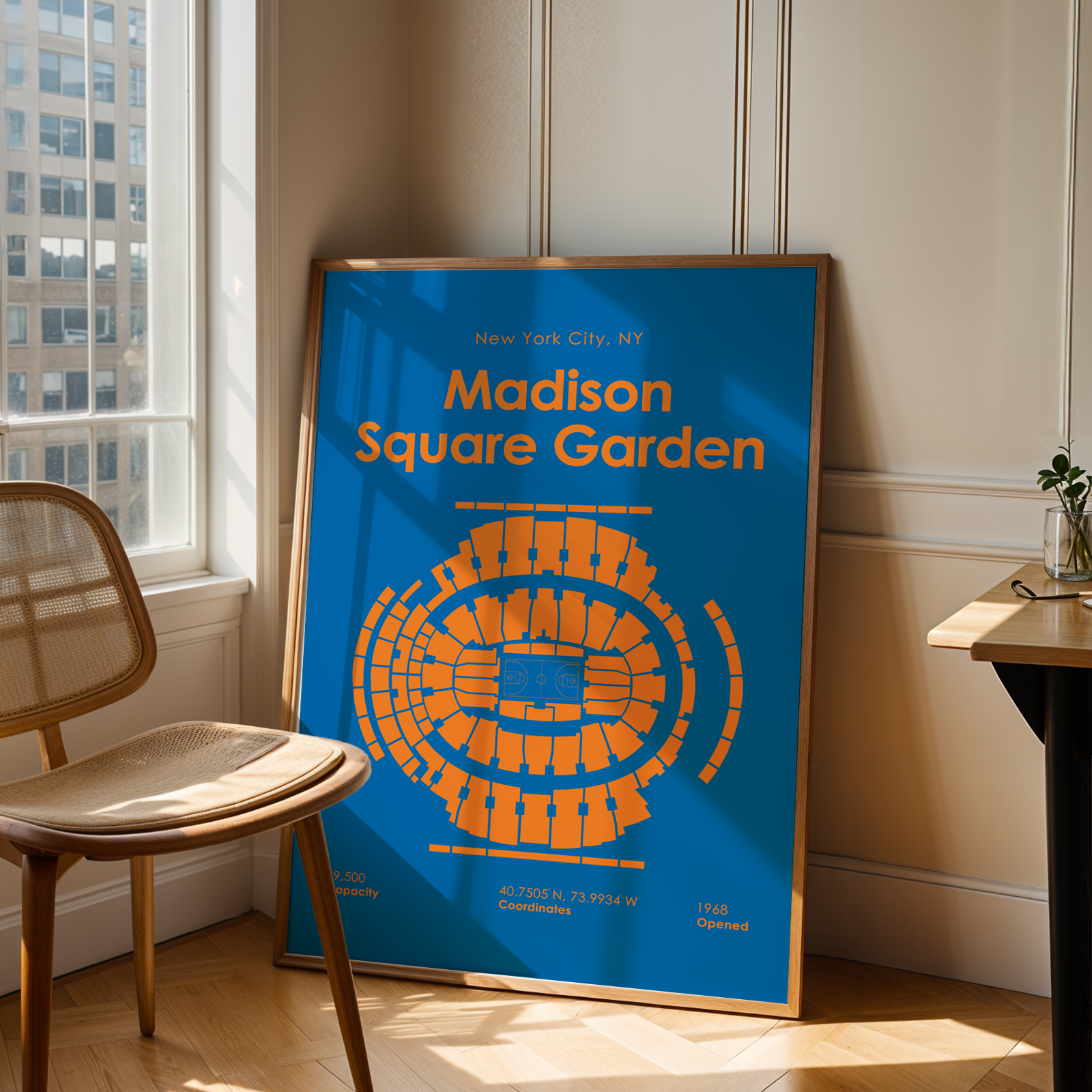 Framed poster of Madison Square Garden in a room with a chair and table.