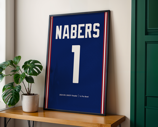 Framed sports jersey with 'NABERS' and number '1' on a wooden shelf.