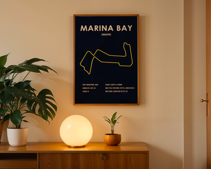 Framed map of Marina Bay on a wall above a wooden cabinet with decorative items.