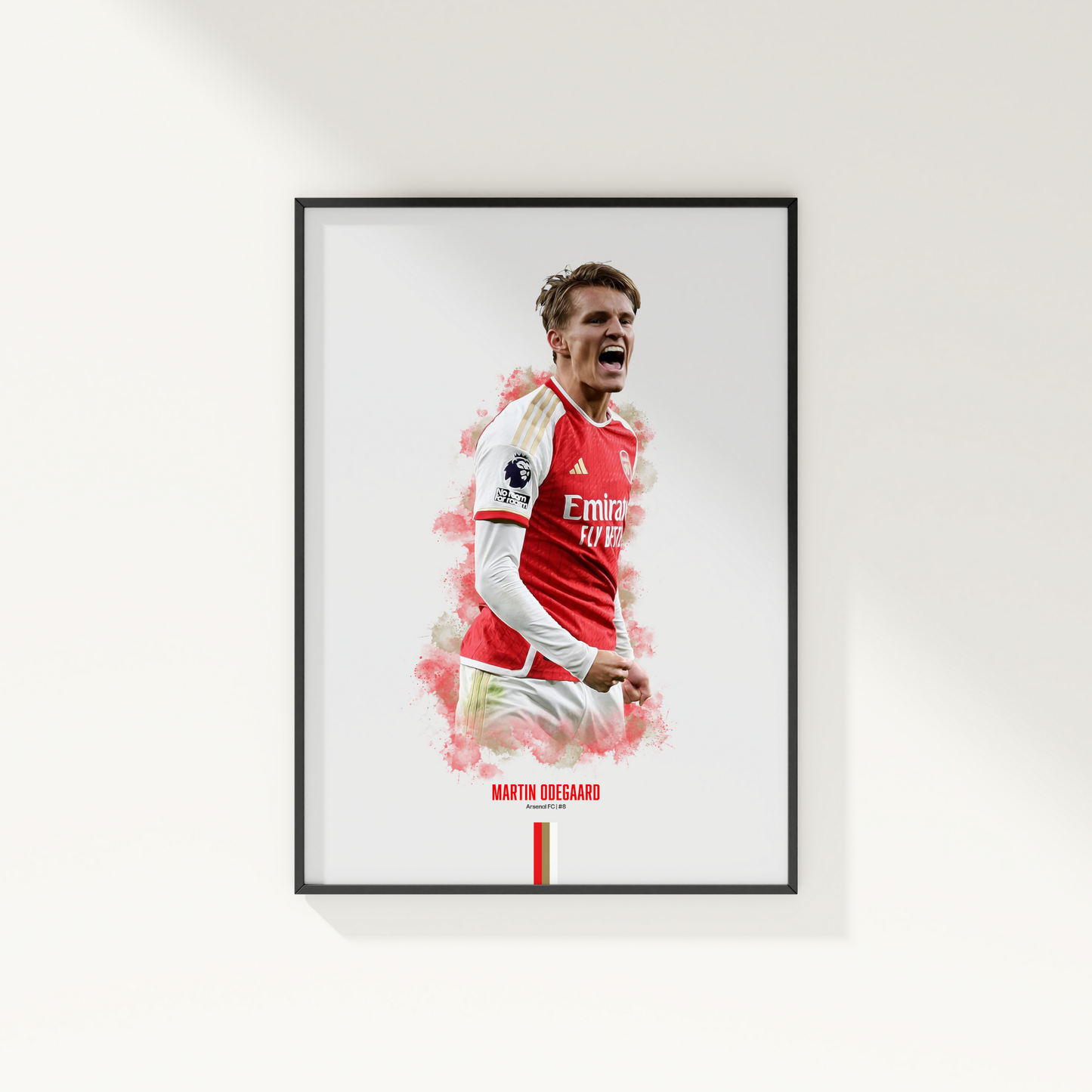 framed poster mockup of soccer player martin odegaard hanging on a white wall