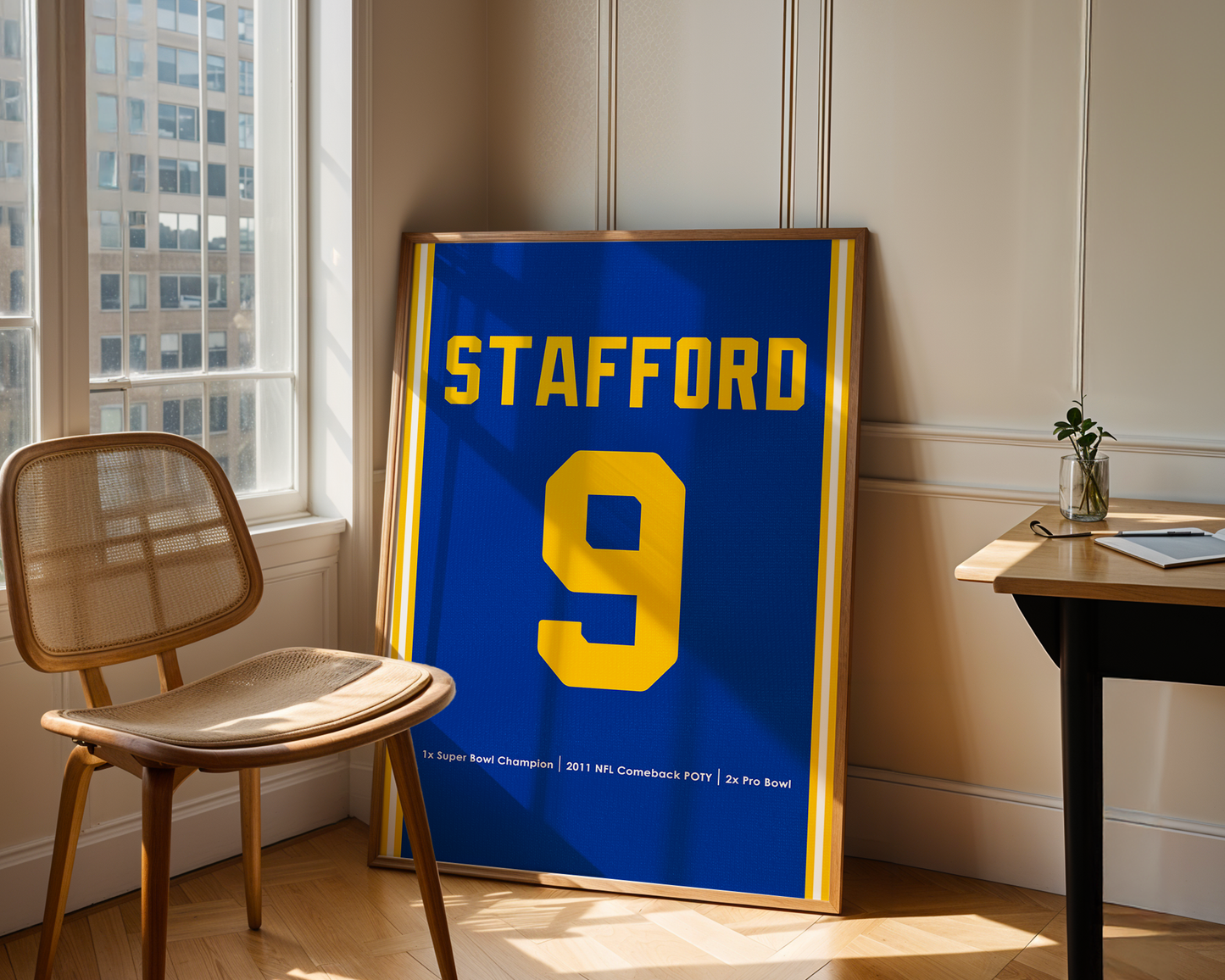 Framed sports jersey with 'Stafford' and number '9' in a room with a window and chair.
