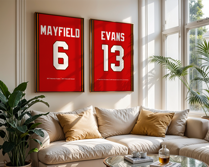 Two framed sports jerseys with names and numbers on a wall above a sofa.