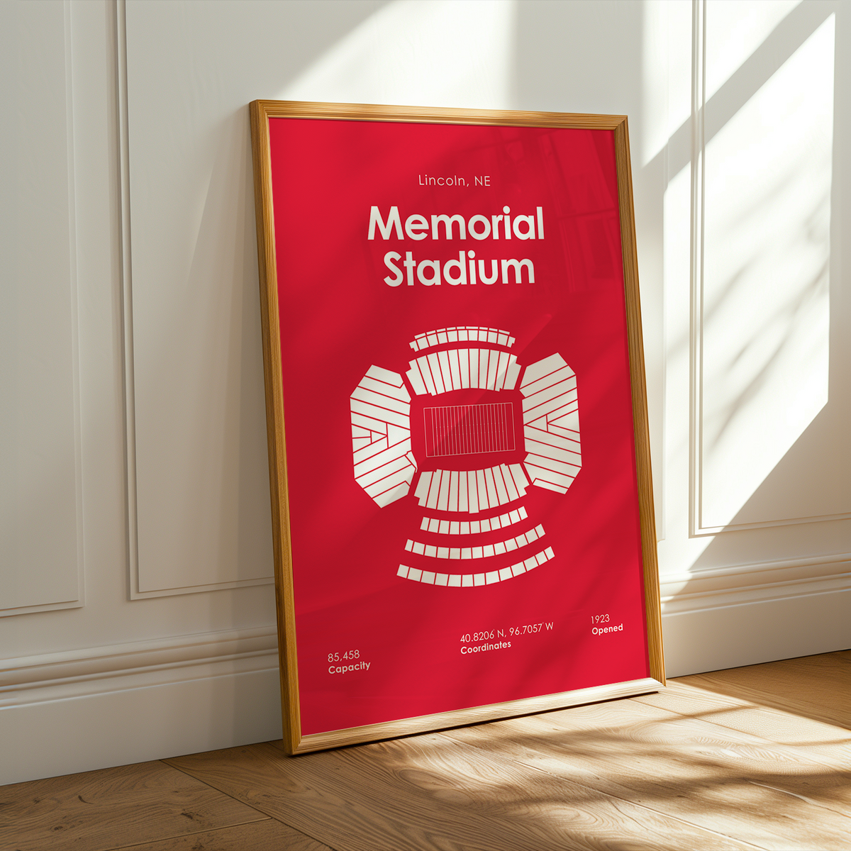 A framed red poster of Memorial Stadium in Lincoln, NE.