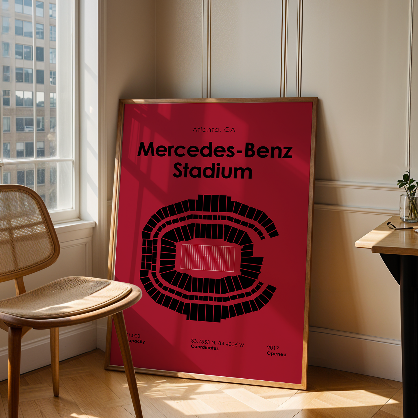 Poster of Mercedes-Benz Stadium in a room with a chair and table.