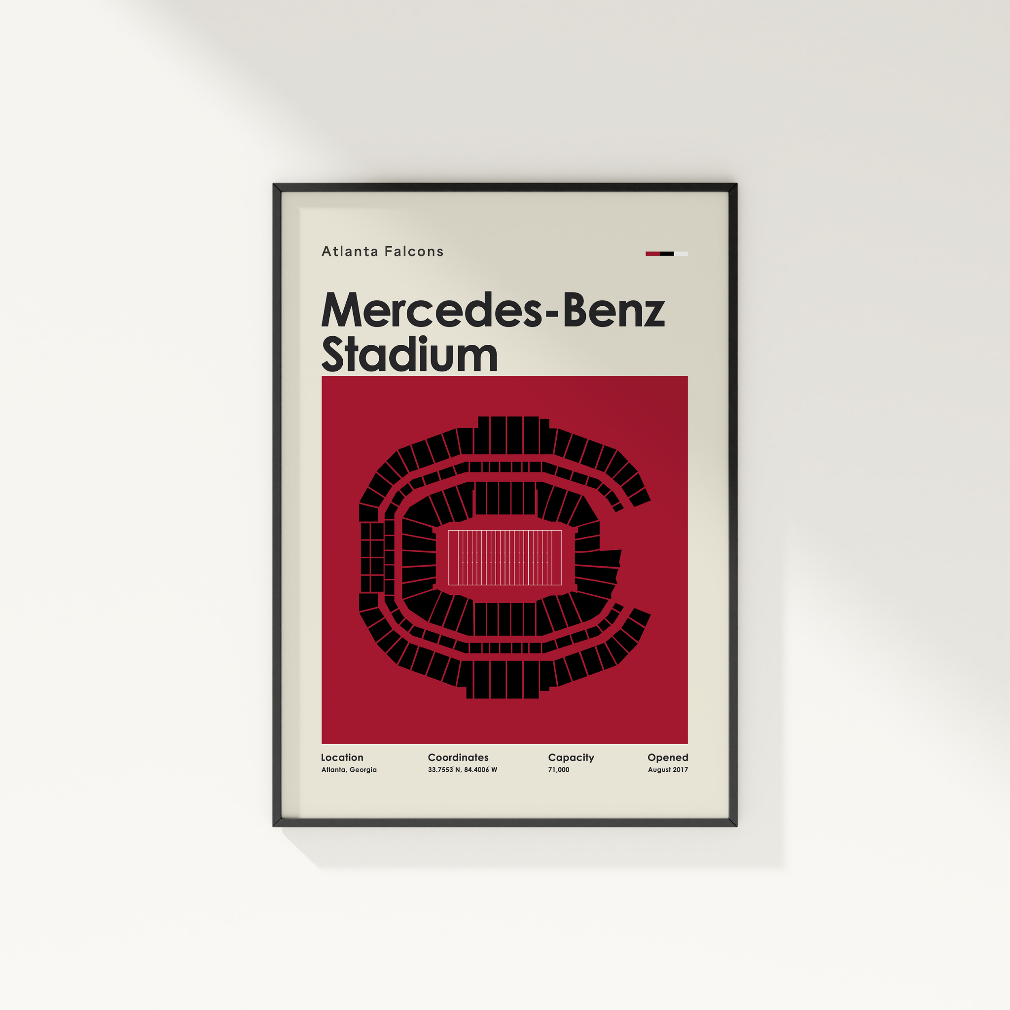 Framed poster of Mercedes-Benz Stadium with Atlanta Falcons branding on a white wall.