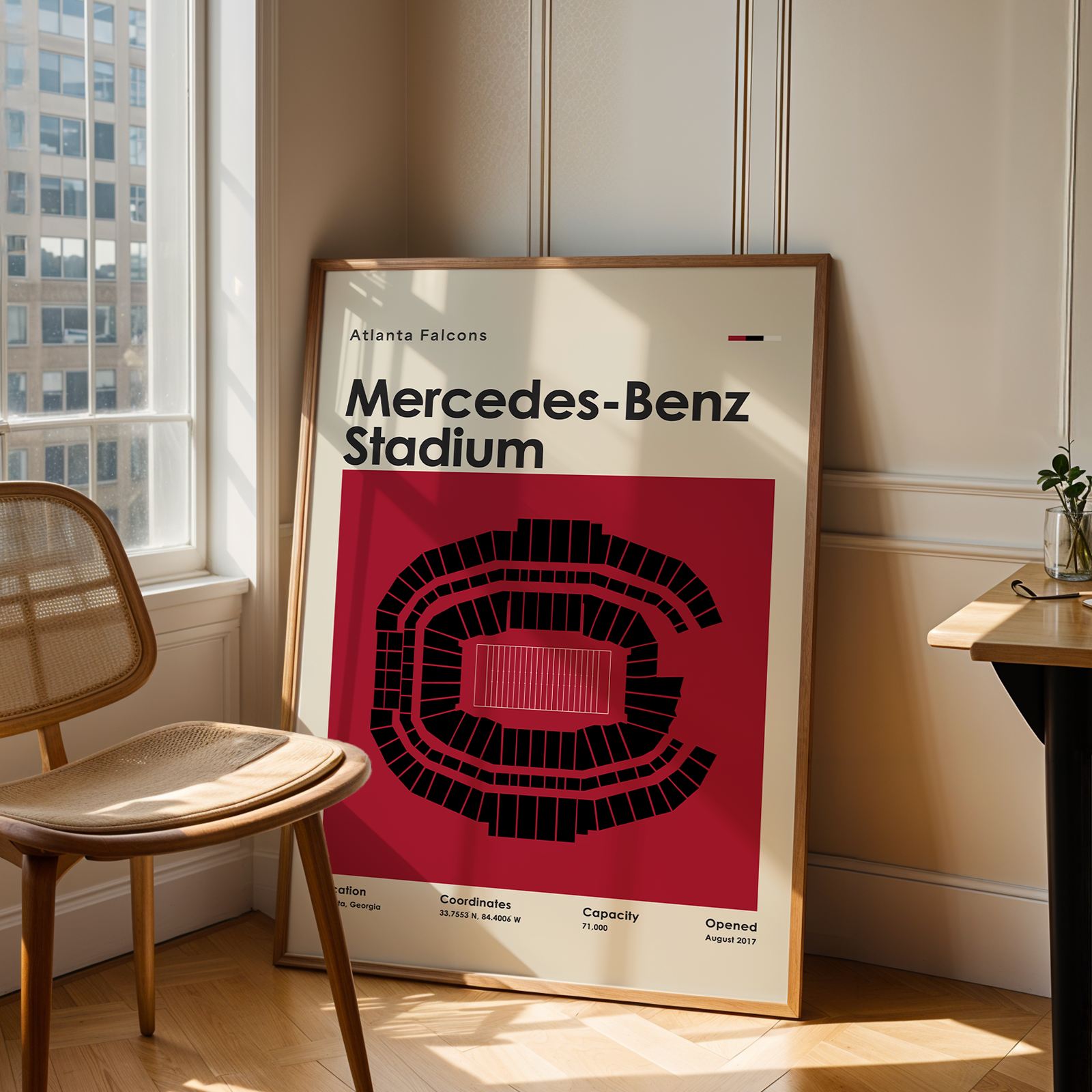 Poster of Mercedes-Benz Stadium in a room with a chair and table.