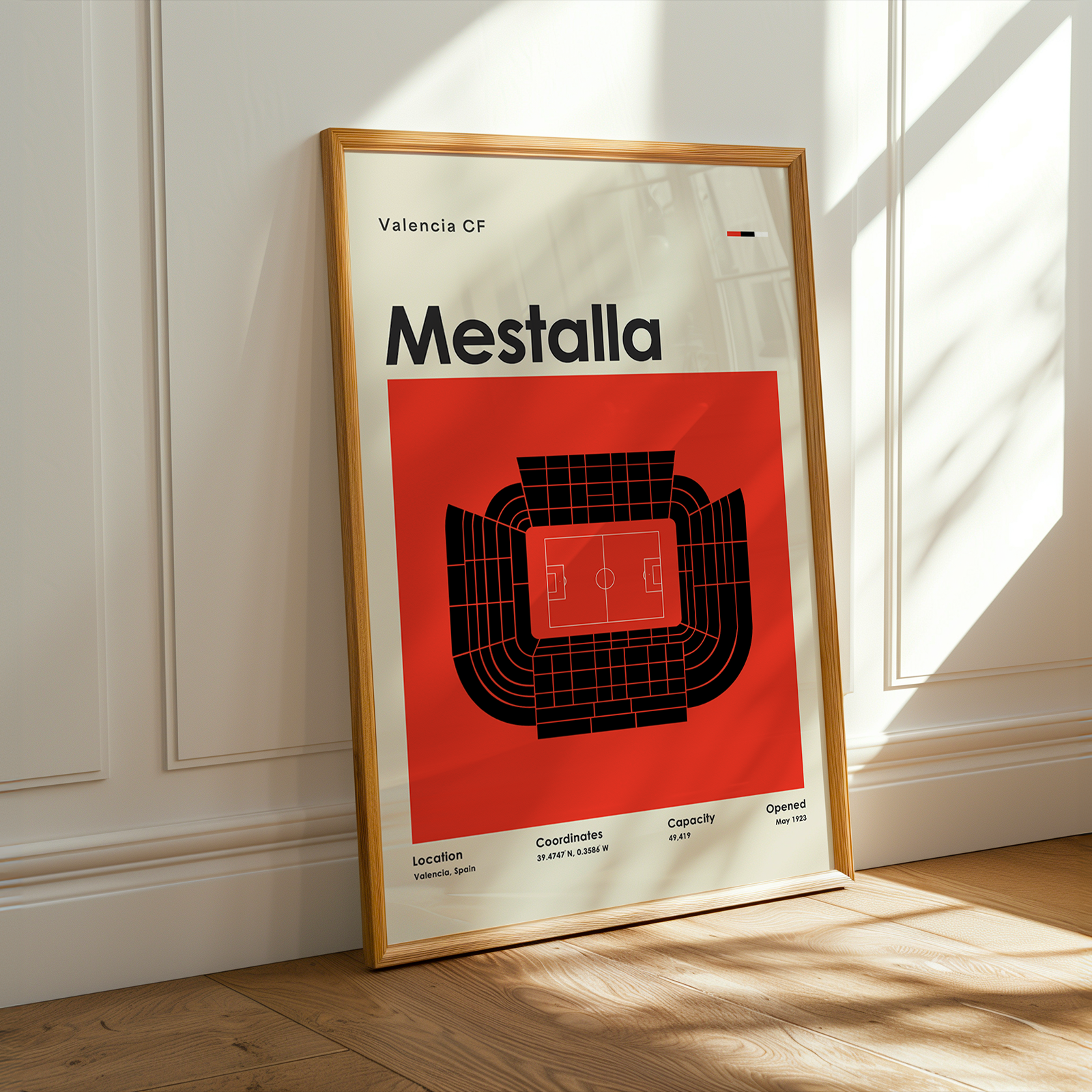 Framed poster of Mestalla stadium with Valencia CF branding on a wall.