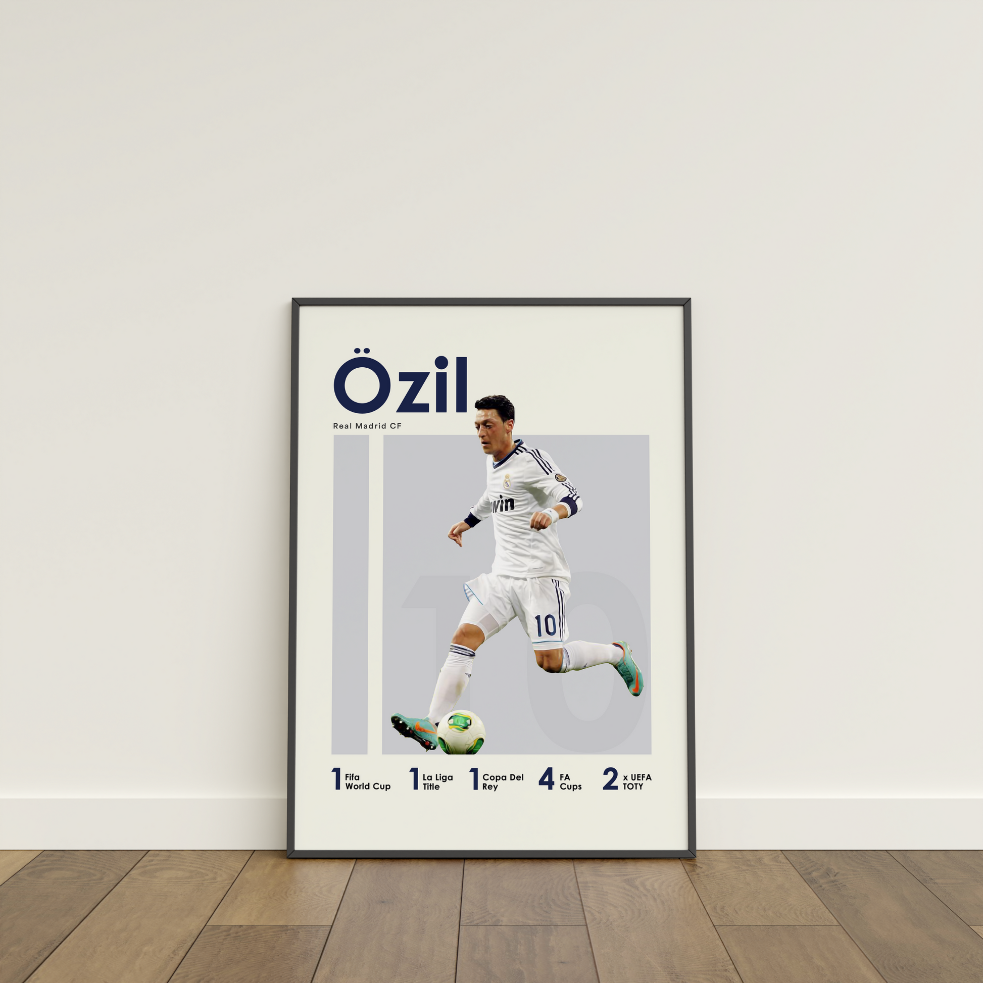 framed poster mockup of football player mesut ozil leaning on a white wall