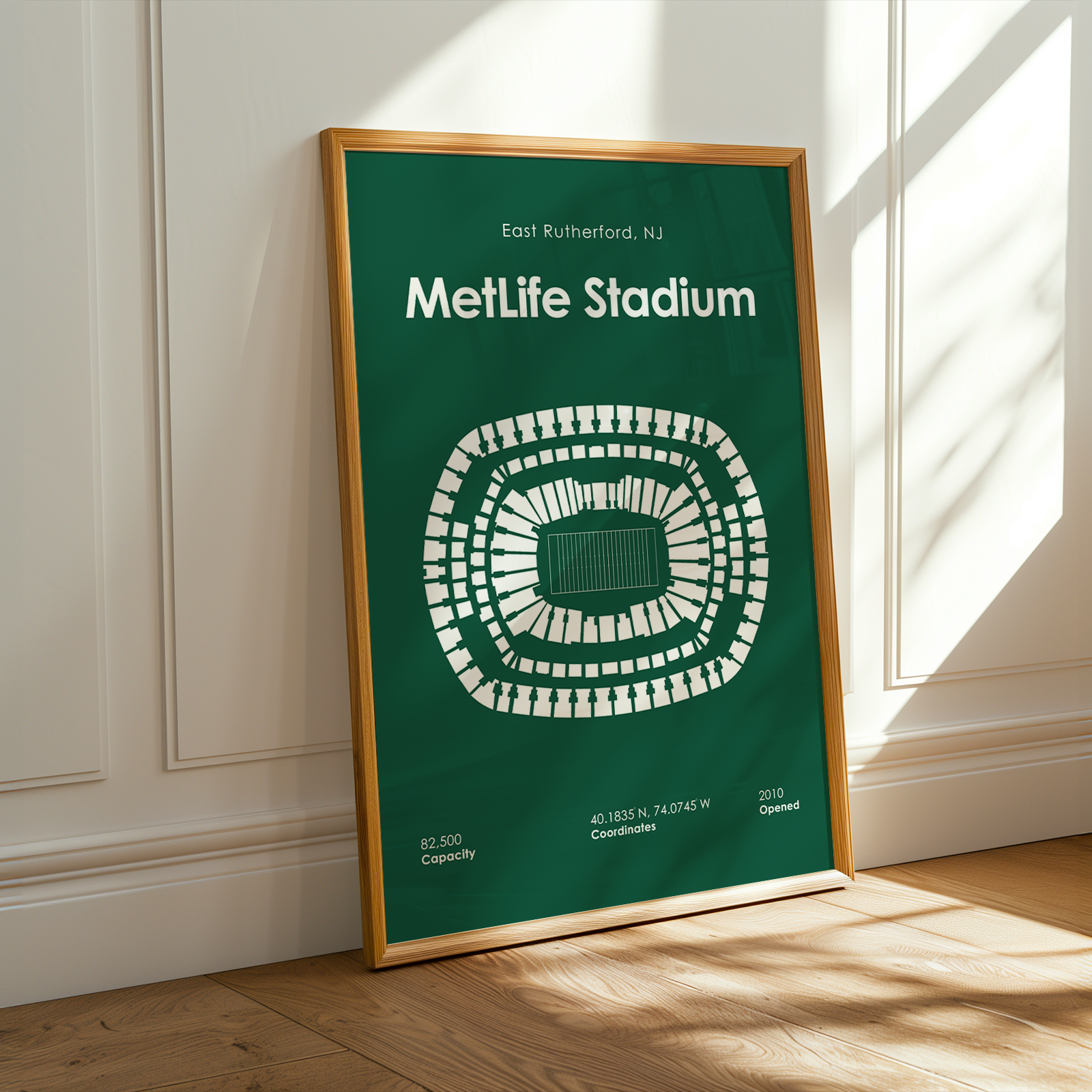 Framed poster of MetLife Stadium on a wall with sunlight casting shadows.