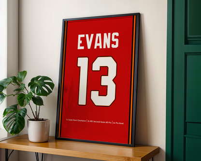 Framed sports jersey with 'EVANS 13' on a wooden shelf with a plant.
