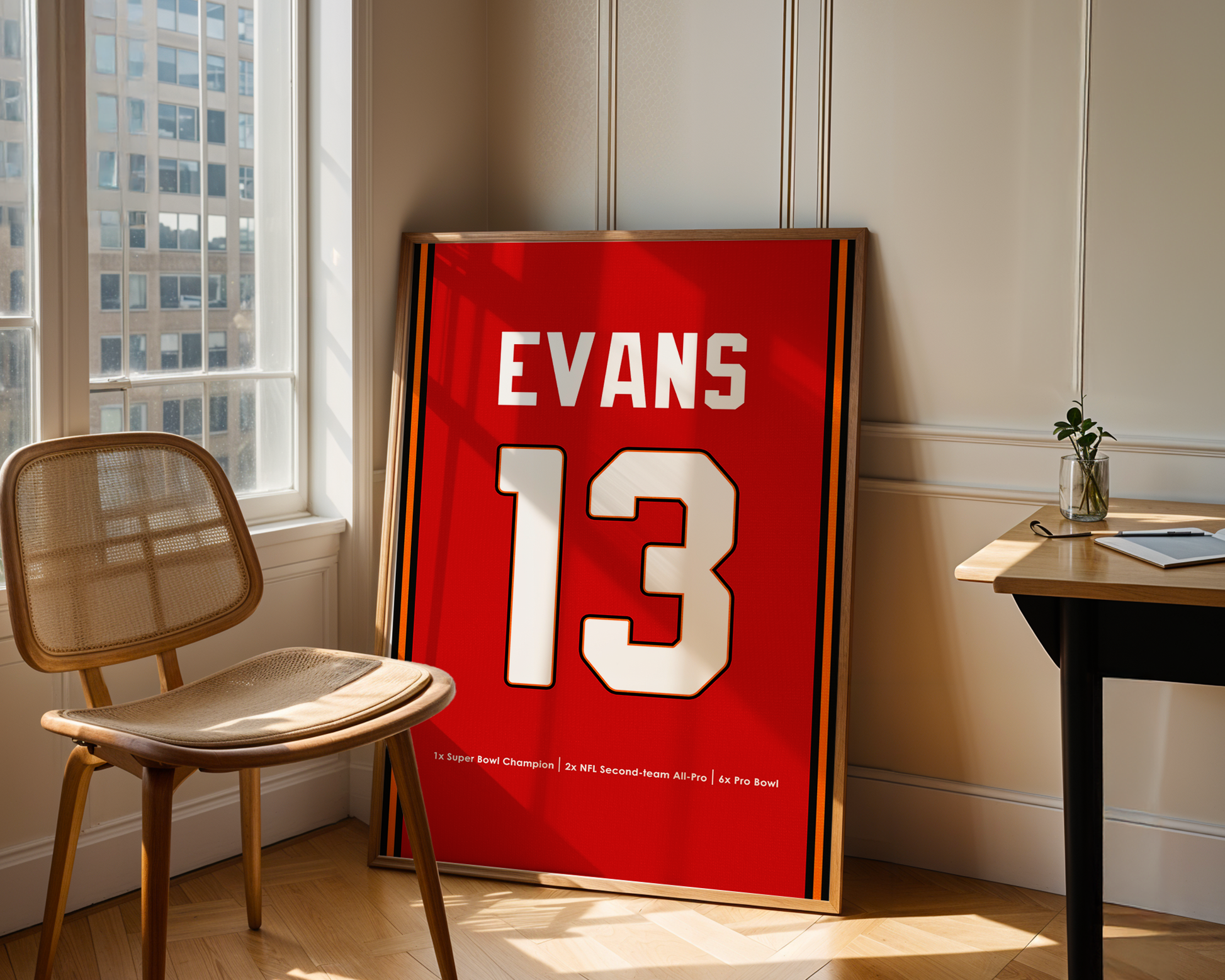 Red sports jersey with 'EVANS 13' on a stand in a room with a chair and table.