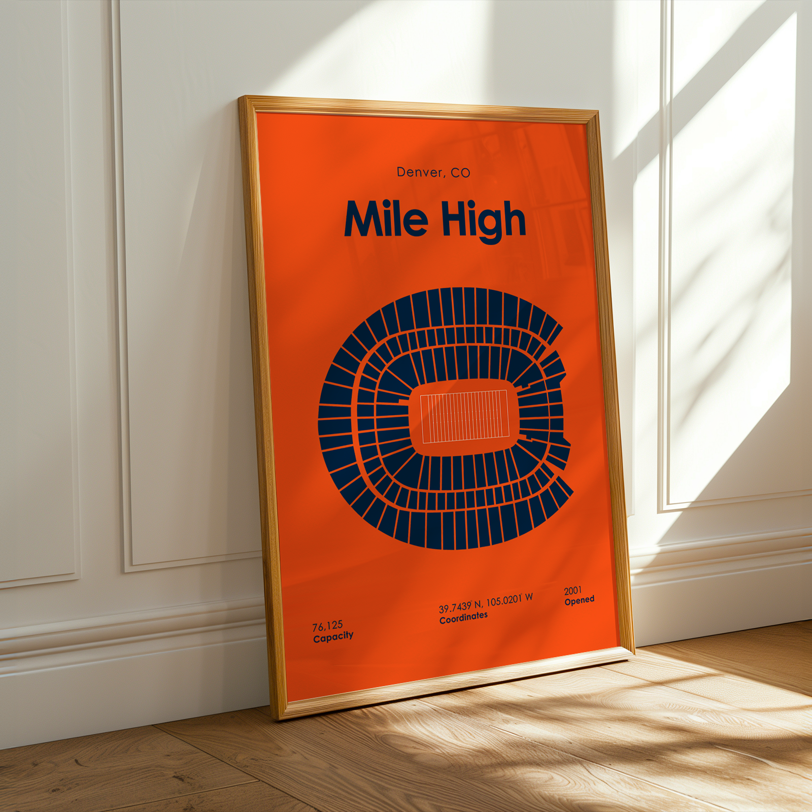 Framed poster with 'Mile High' design on an orange background, leaning against a white wall.