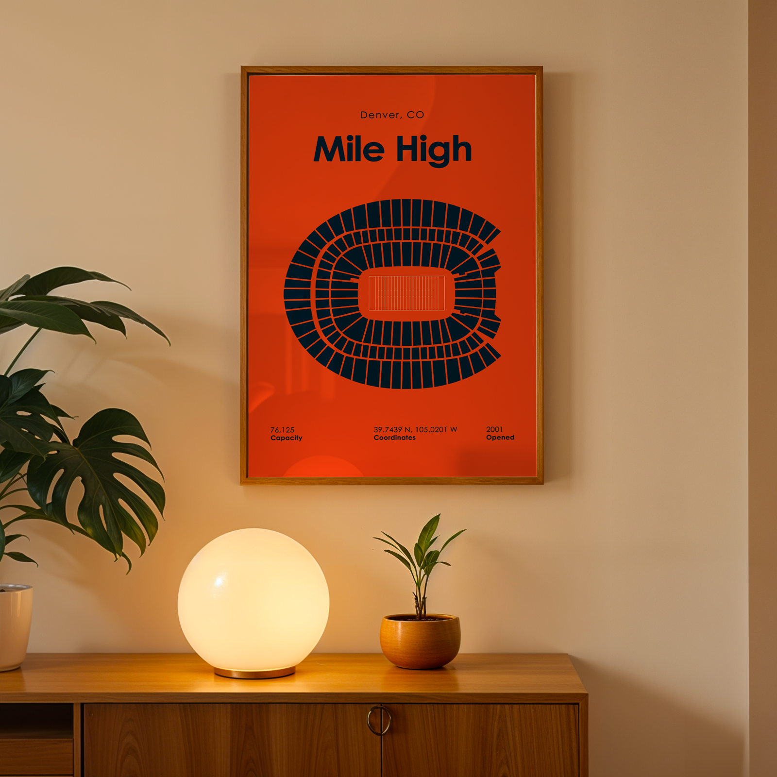 Framed 'Mile High' stadium poster on a wall above a wooden cabinet with decorative items.