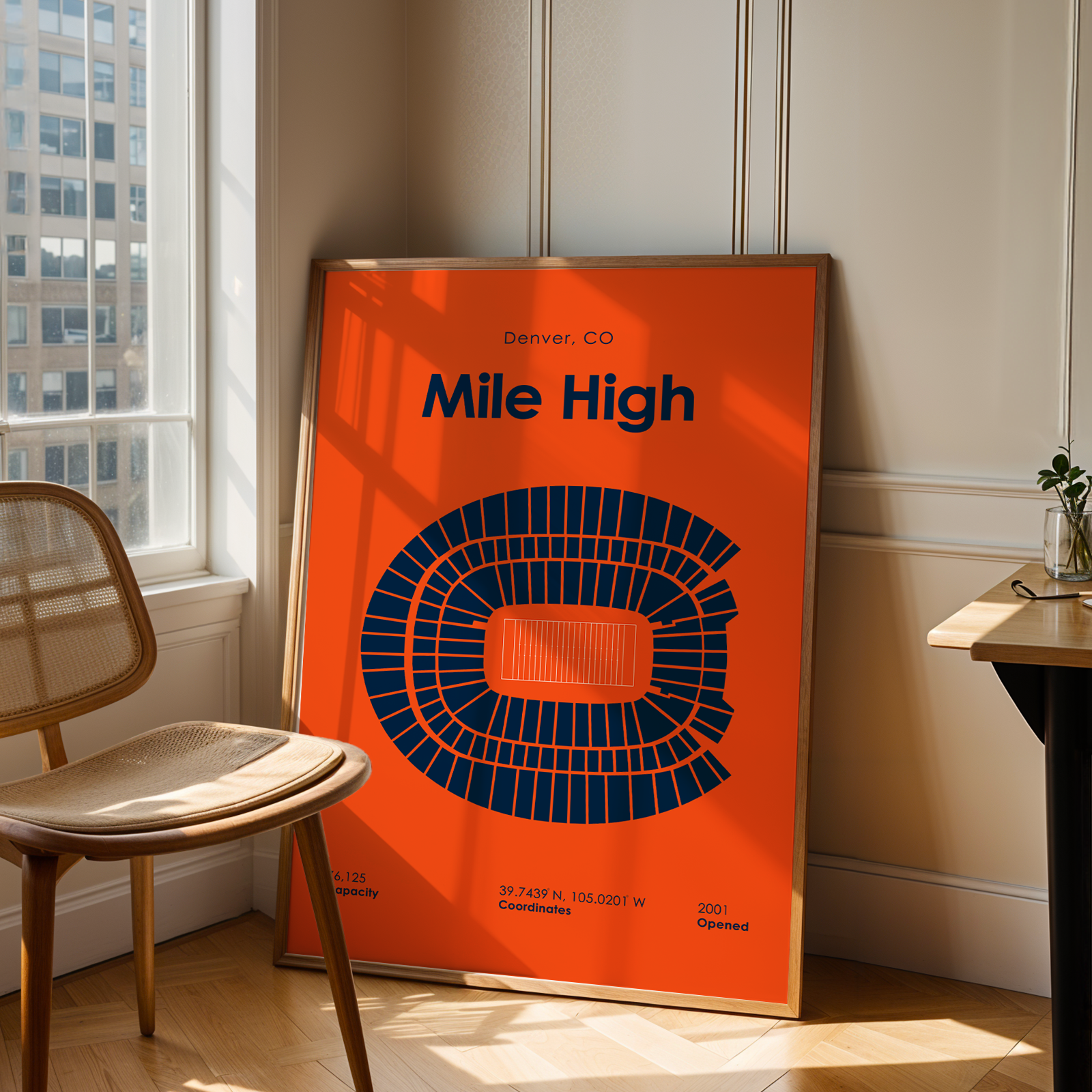Orange poster with 'Mile High' text and seating chart in a room with a chair and table.