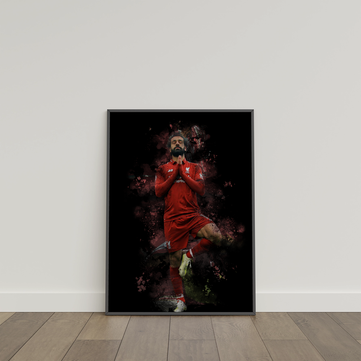 framed poster mockup of soccer  player mo salah leaning on a white wall