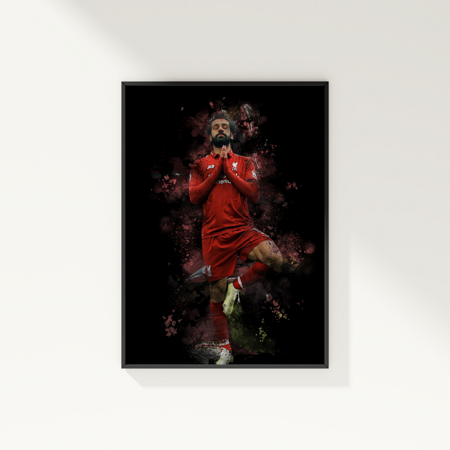 framed poster mockup of soccer player mo salah hanging on a white wall