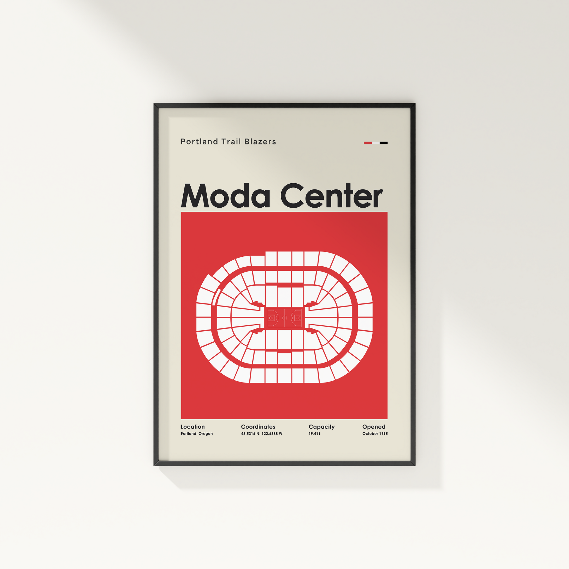 Framed poster of Moda Center with Portland Trail Blazers text on a white wall.