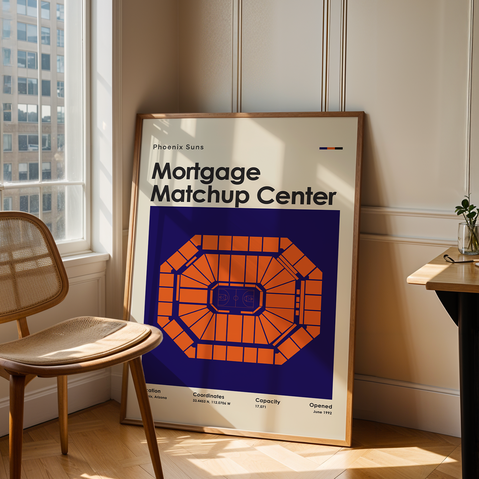 Framed poster of a 'Mortgage Matchup Center' on a wall next to a chair and table.